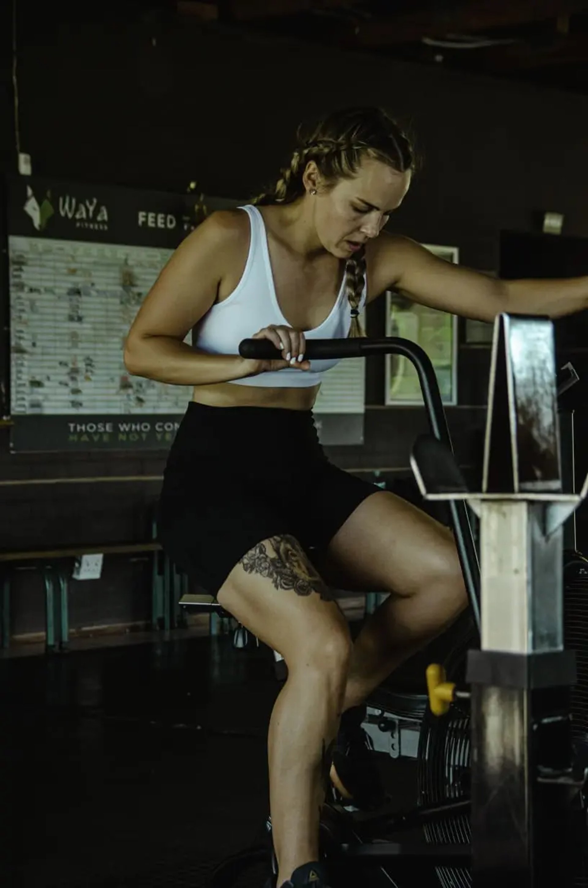 blond woman on CrossFit air bike