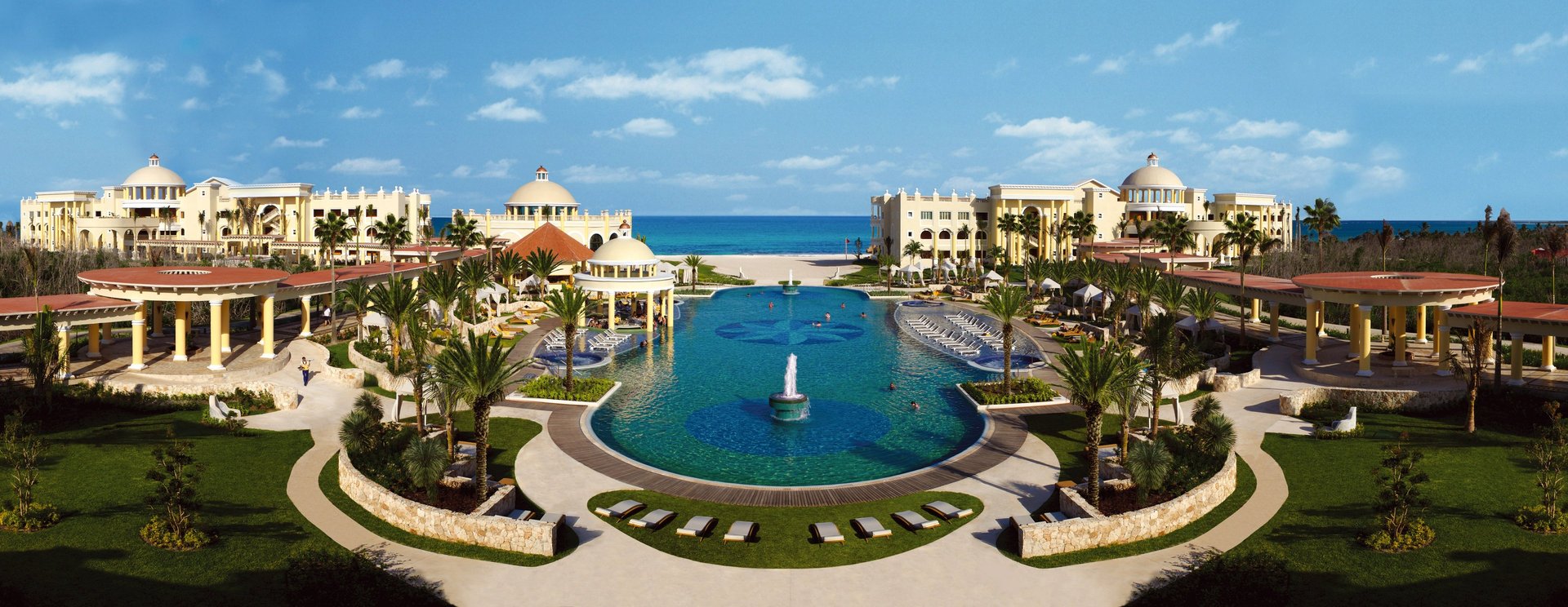 woman wearing yellow long-sleeved dress under white clouds and blue sky during daytime