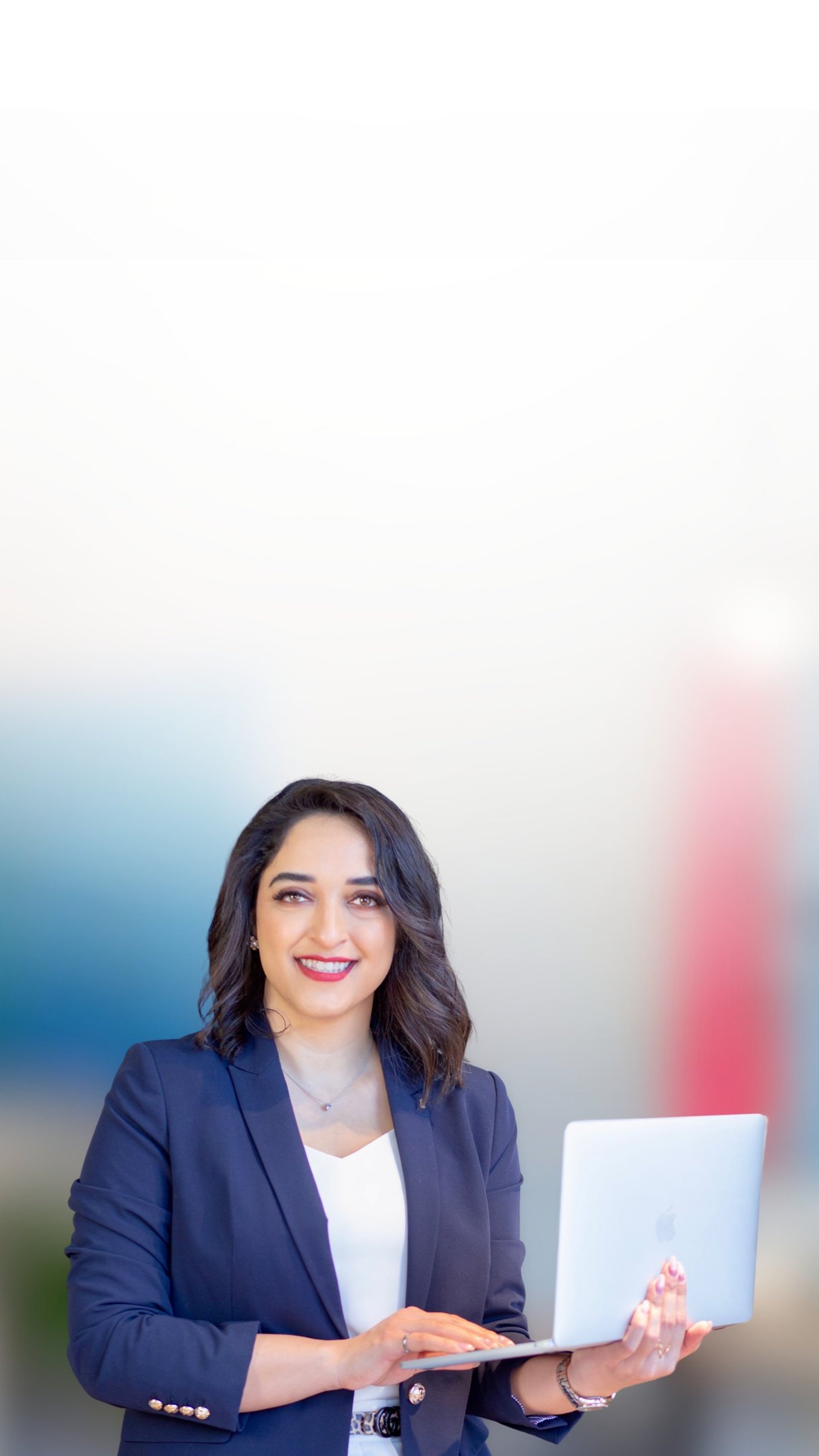 woman in teal t-shirt sitting beside woman in suit jacket