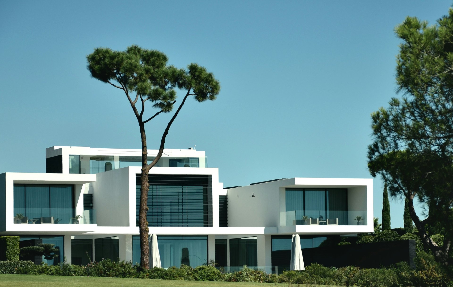an abstract photo of a curved building with a blue sky in the background