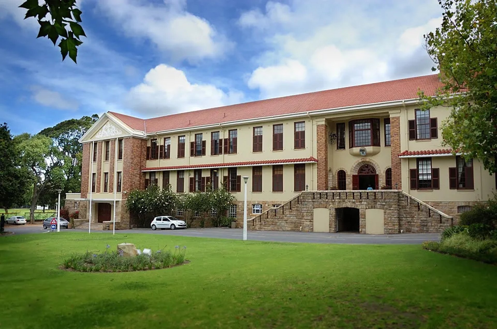 woman wearing yellow long-sleeved dress under white clouds and blue sky during daytime
