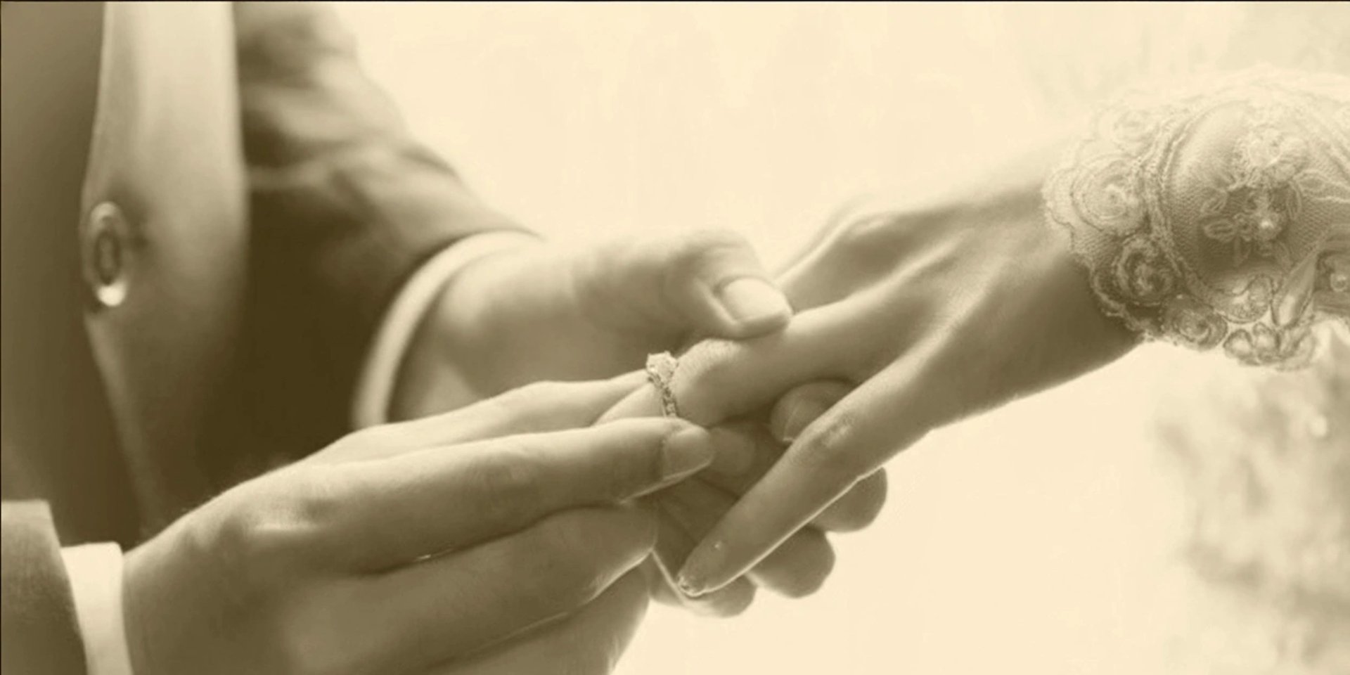 gold wedding band on white textile