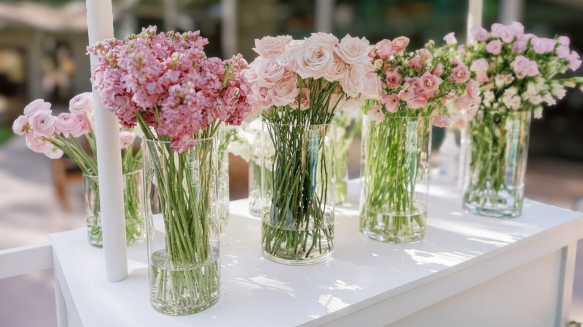 assorted flowers on gray metal bucket