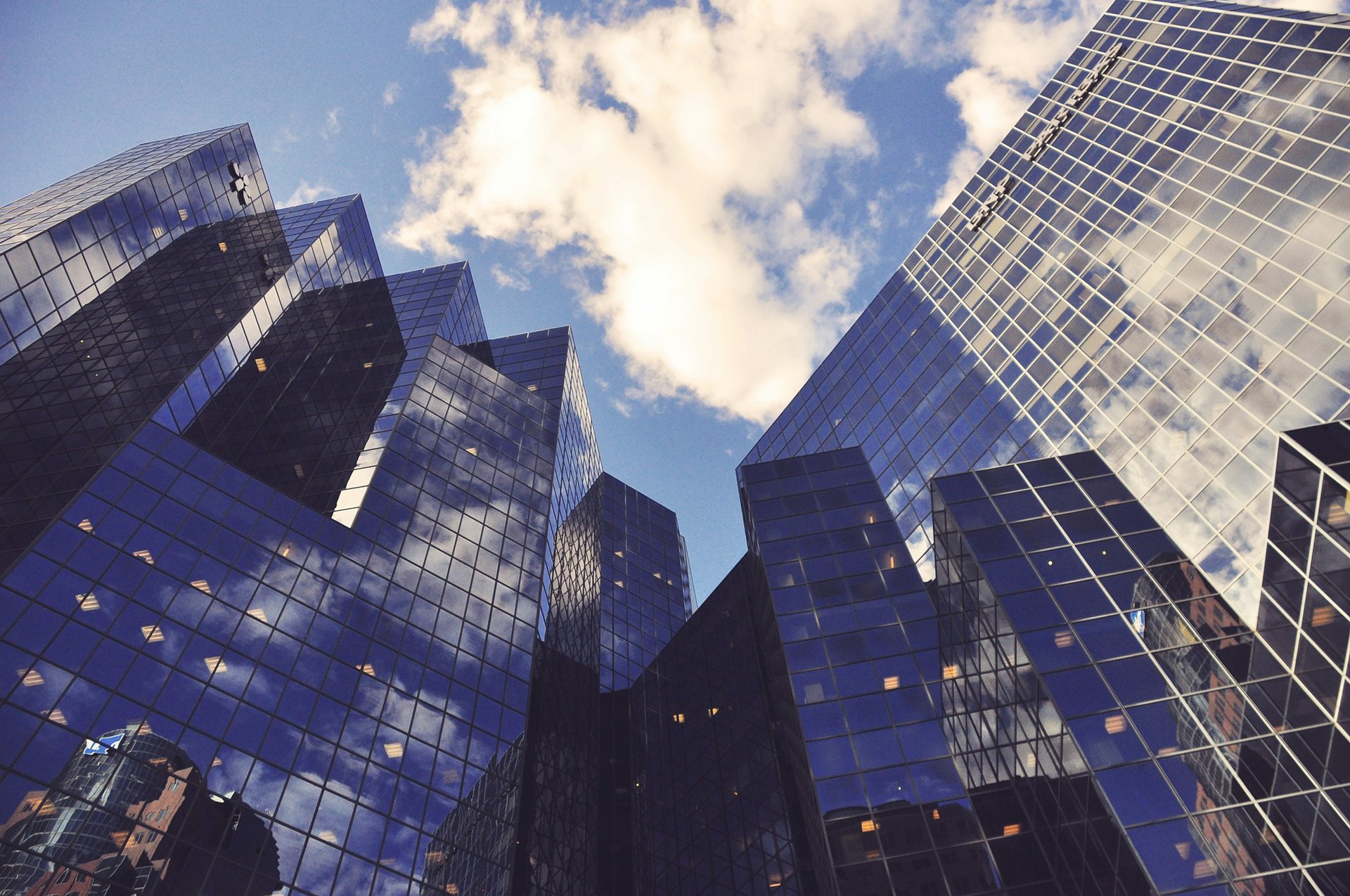 an abstract photo of a curved building with a blue sky in the background