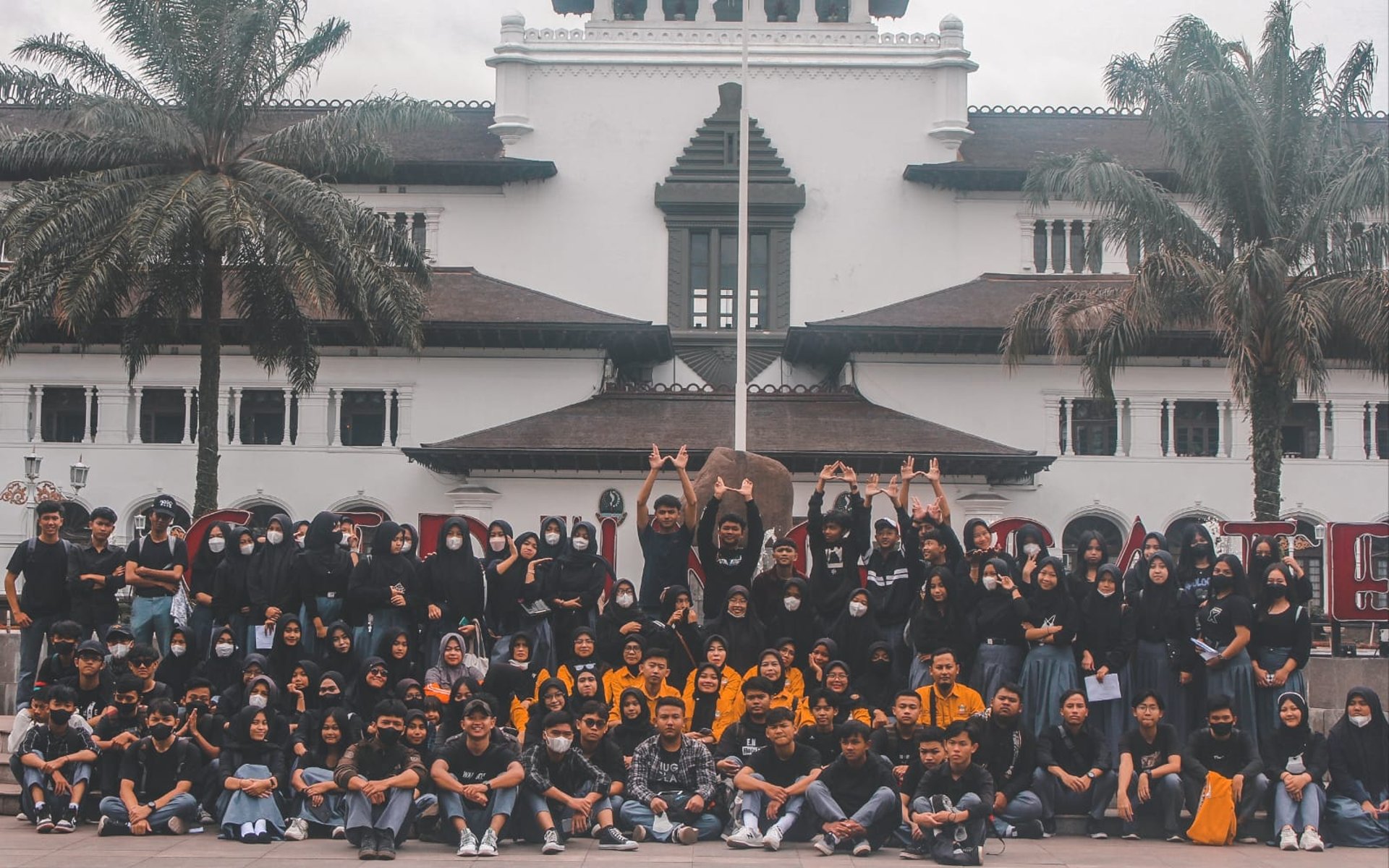 woman wearing yellow long-sleeved dress under white clouds and blue sky during daytime