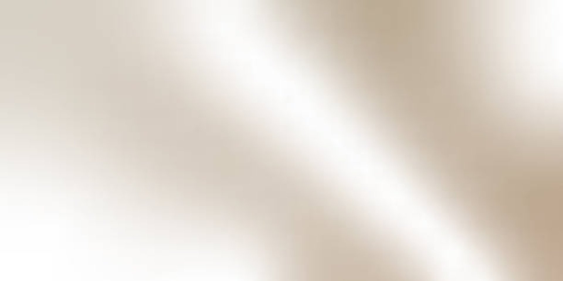 Skincare products with green leaves on a beige surface.