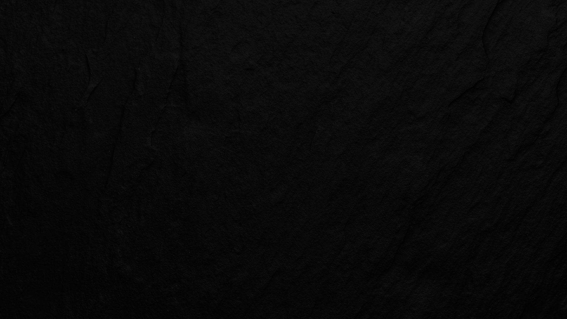 A dark background image of slate stone.