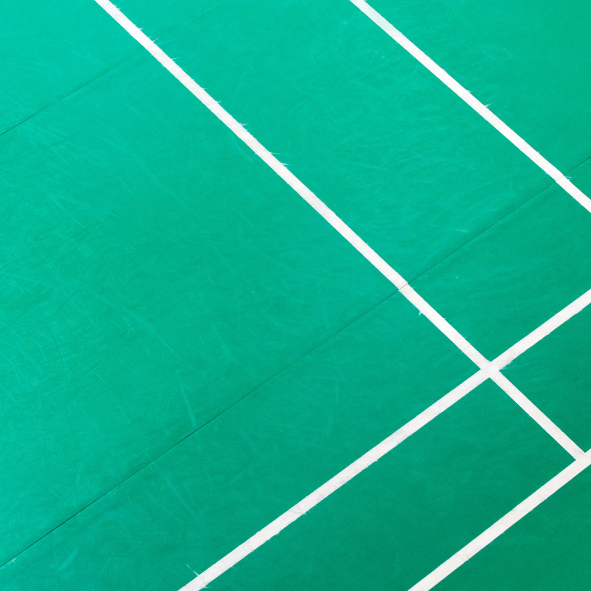 man in white shirt and black pants playing basketball
