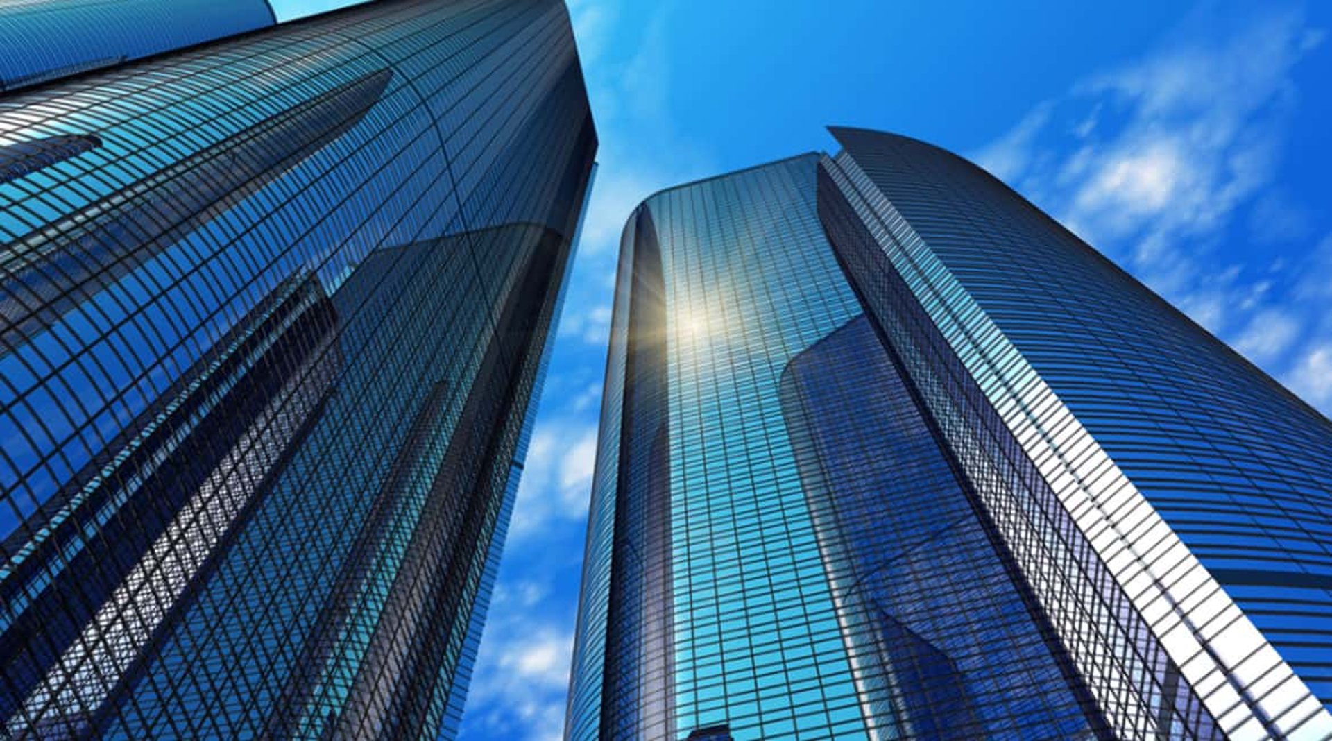 an abstract photo of a curved building with a blue sky in the background