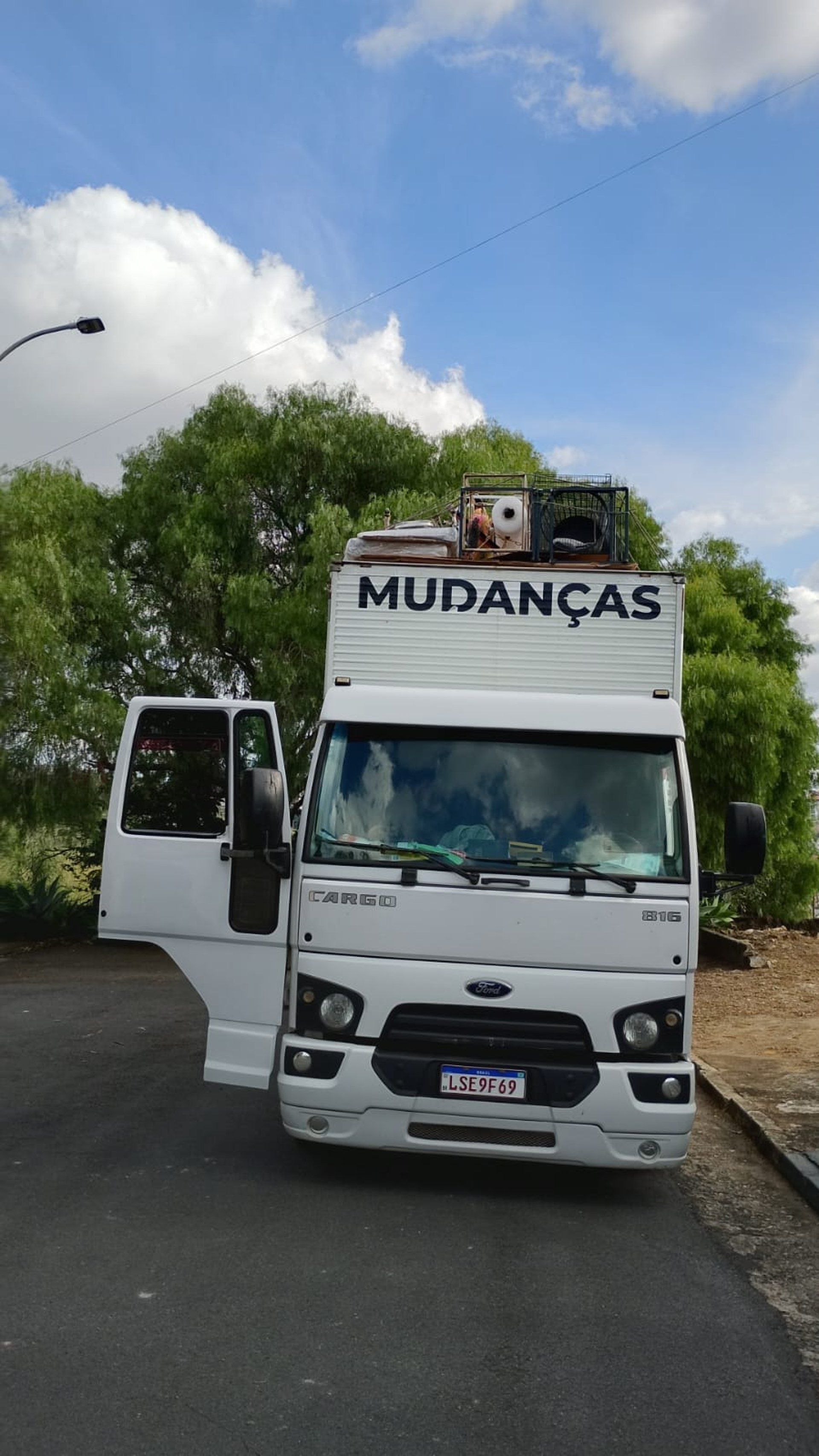 woman wearing yellow long-sleeved dress under white clouds and blue sky during daytime