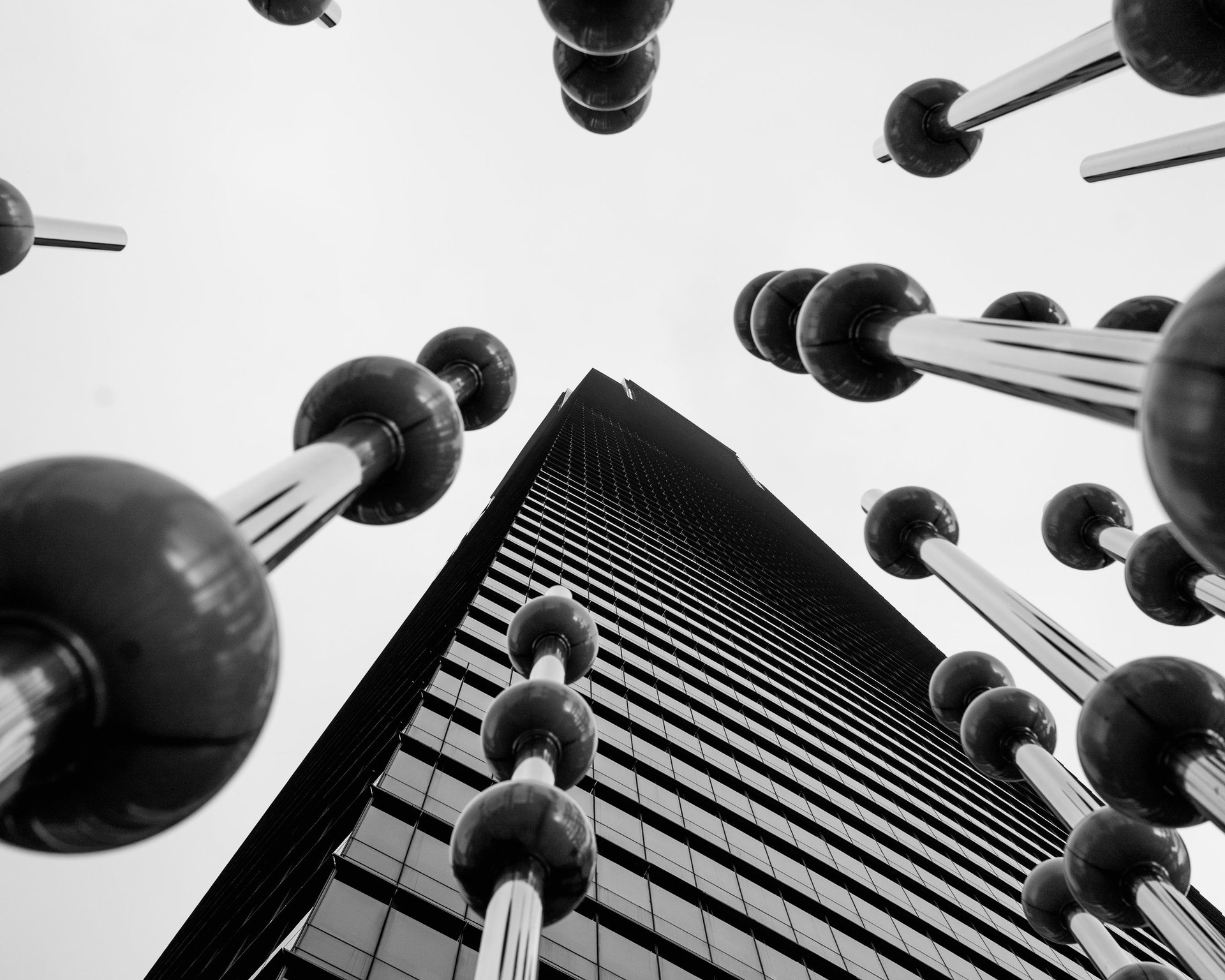 an abstract photo of a curved building with a blue sky in the background