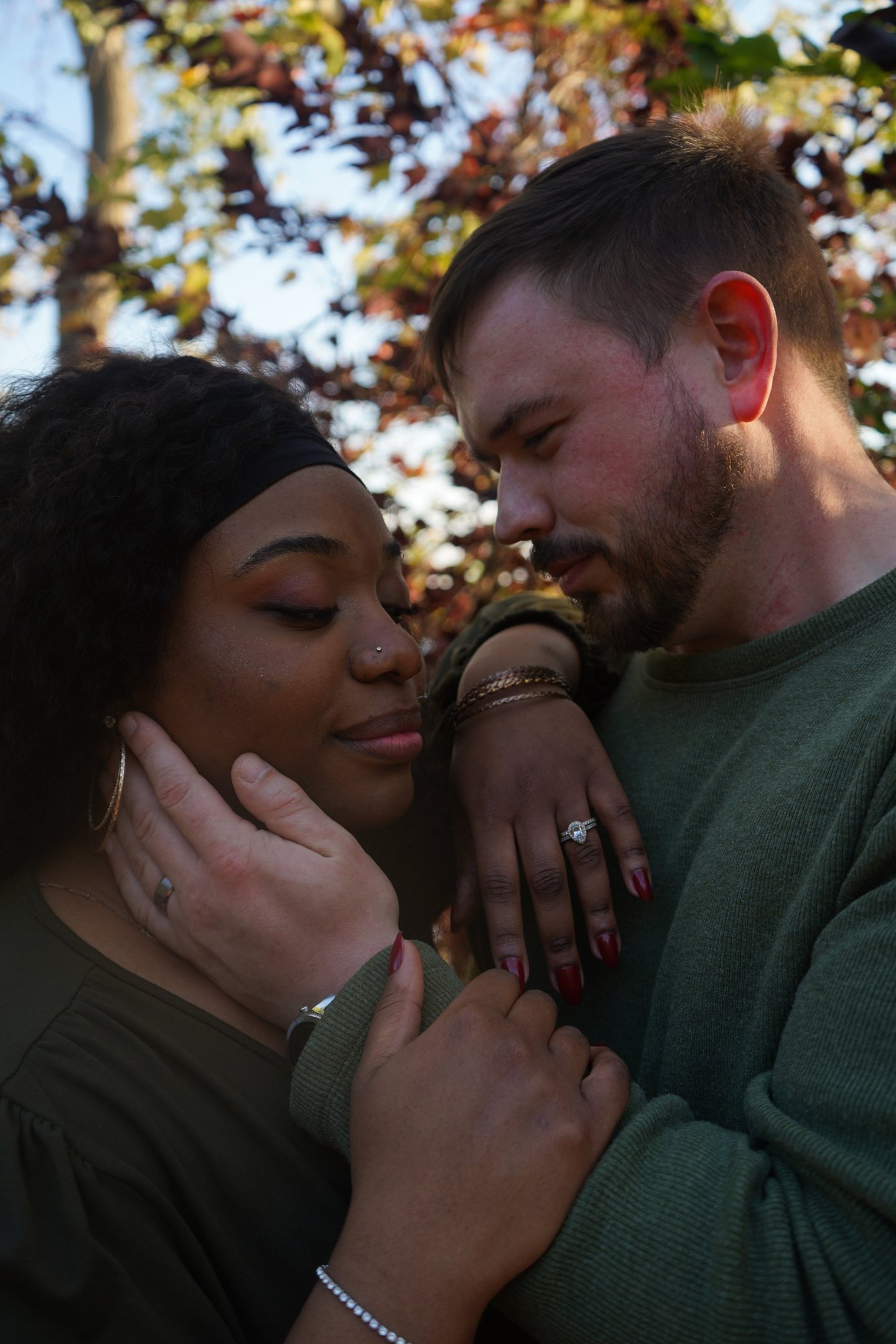 man in black suit kissing woman in white wedding dress