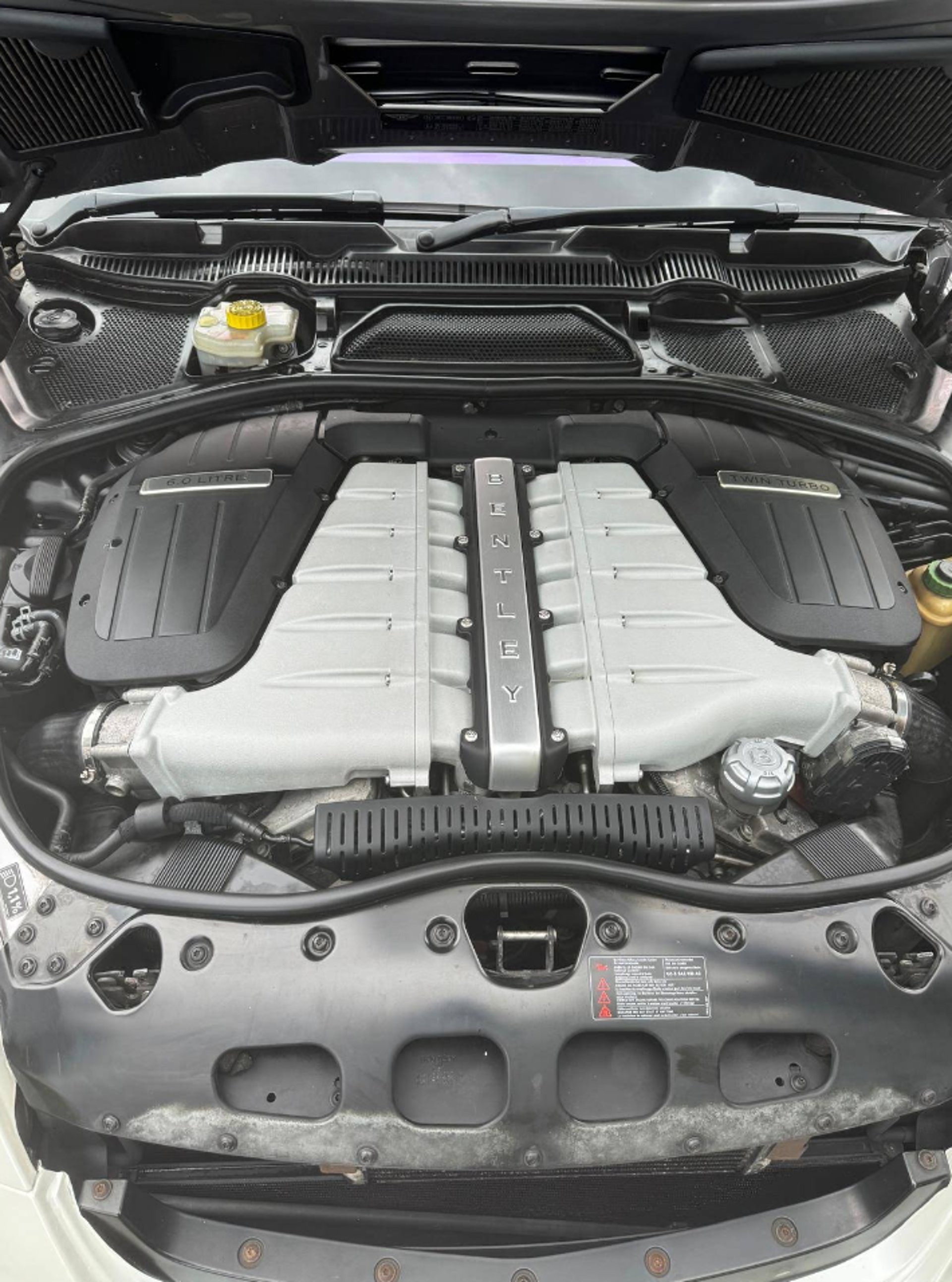 an abstract photo of a curved building with a blue sky in the background