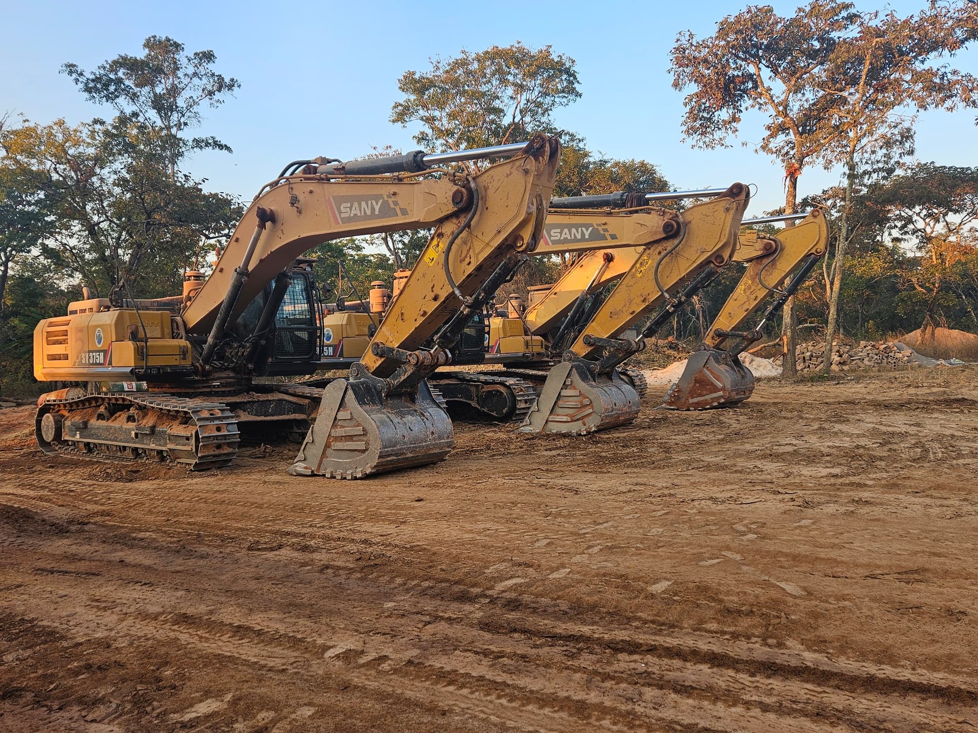 yellow and white excavator on rocky mountain during daytime