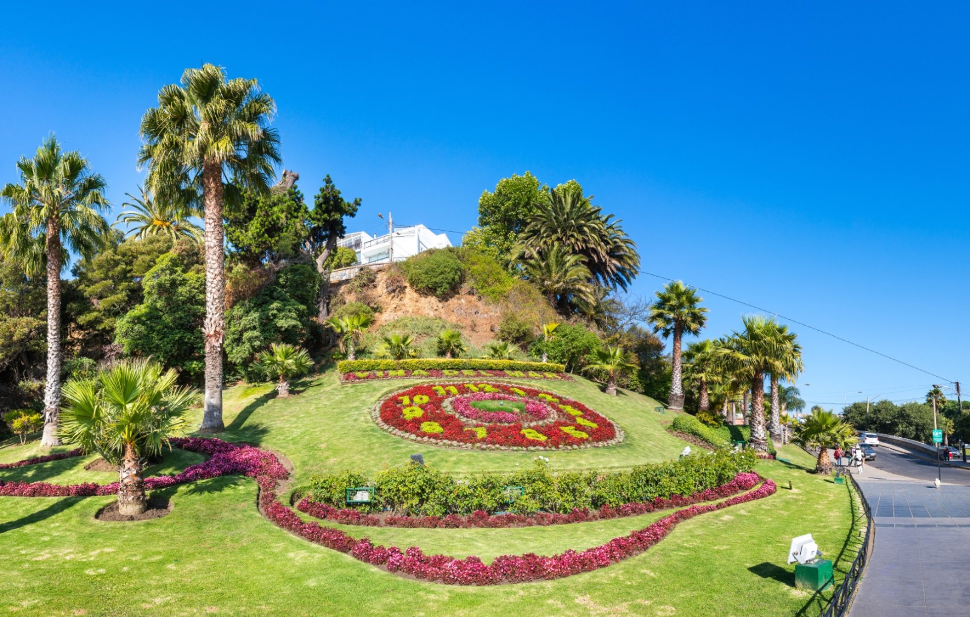 A white tow truck is parked on the street.
