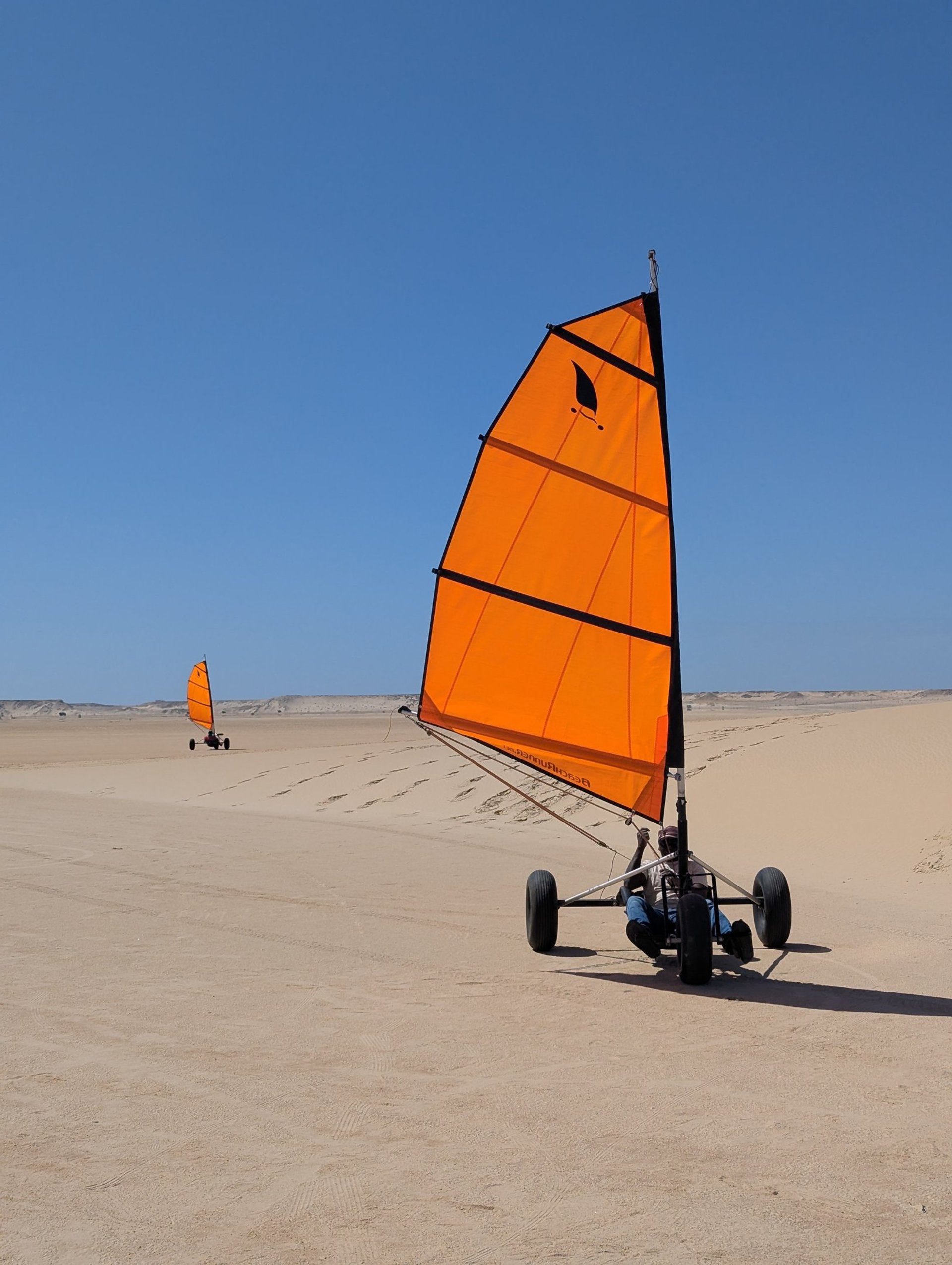 white and brown concrete building near green grass field during daytime