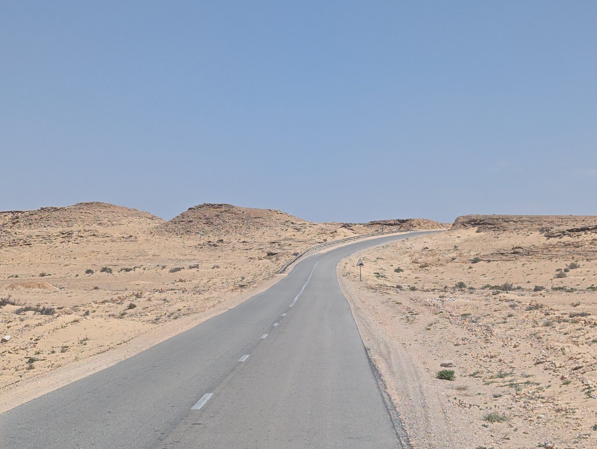 a colorful kite flying through a blue sky