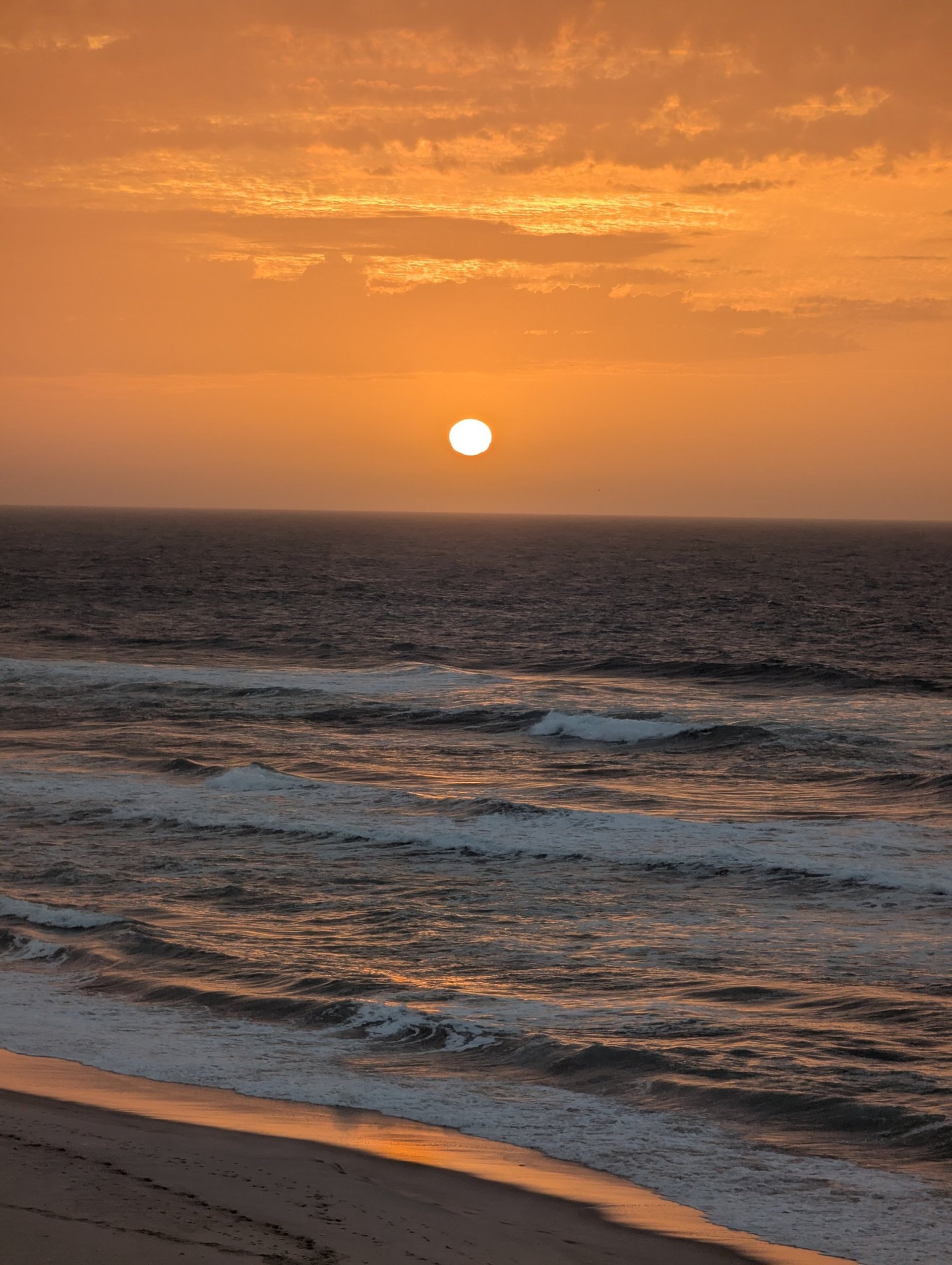 white and brown concrete building near green grass field during daytime