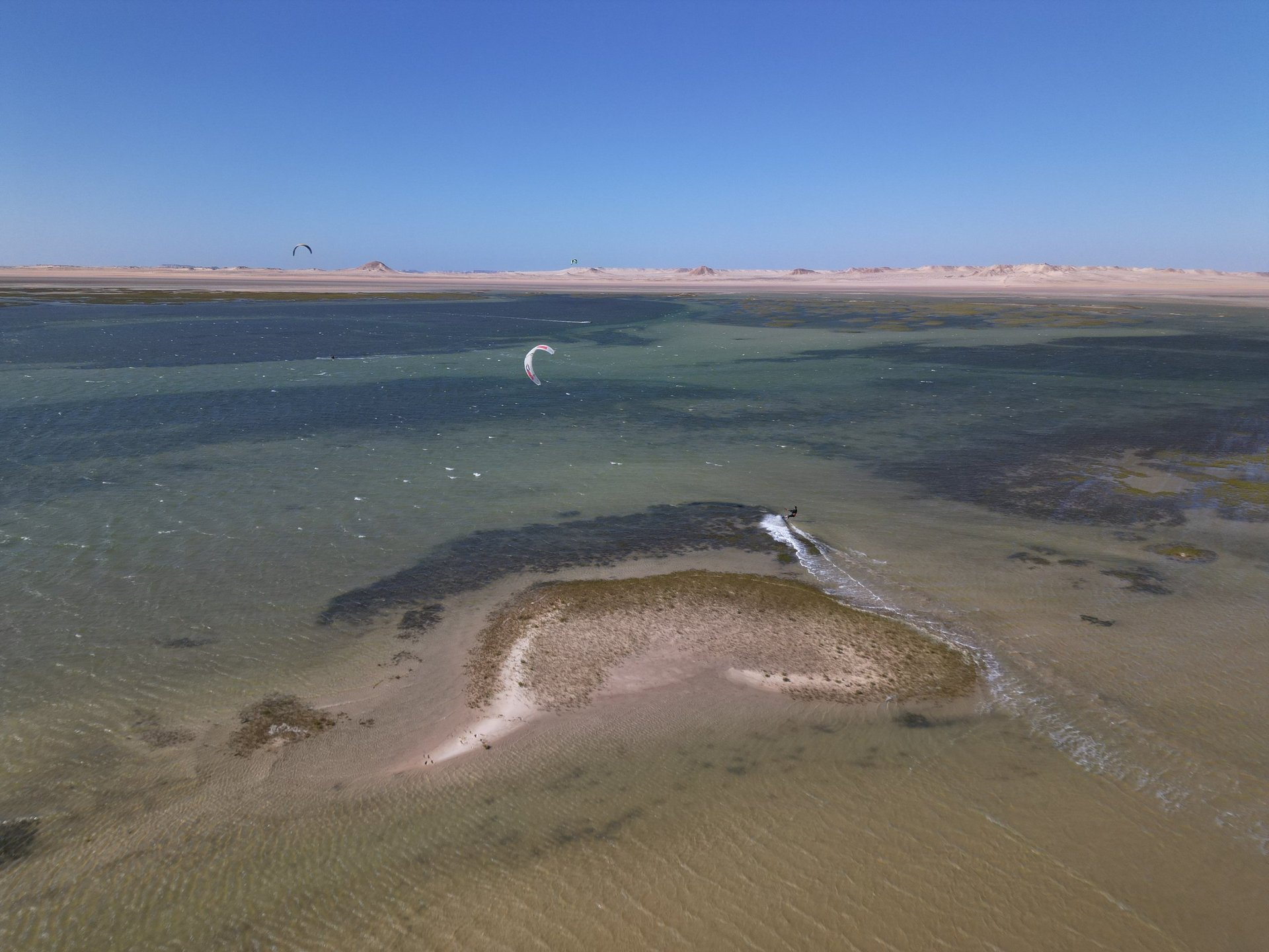 white and brown concrete building near green grass field during daytime