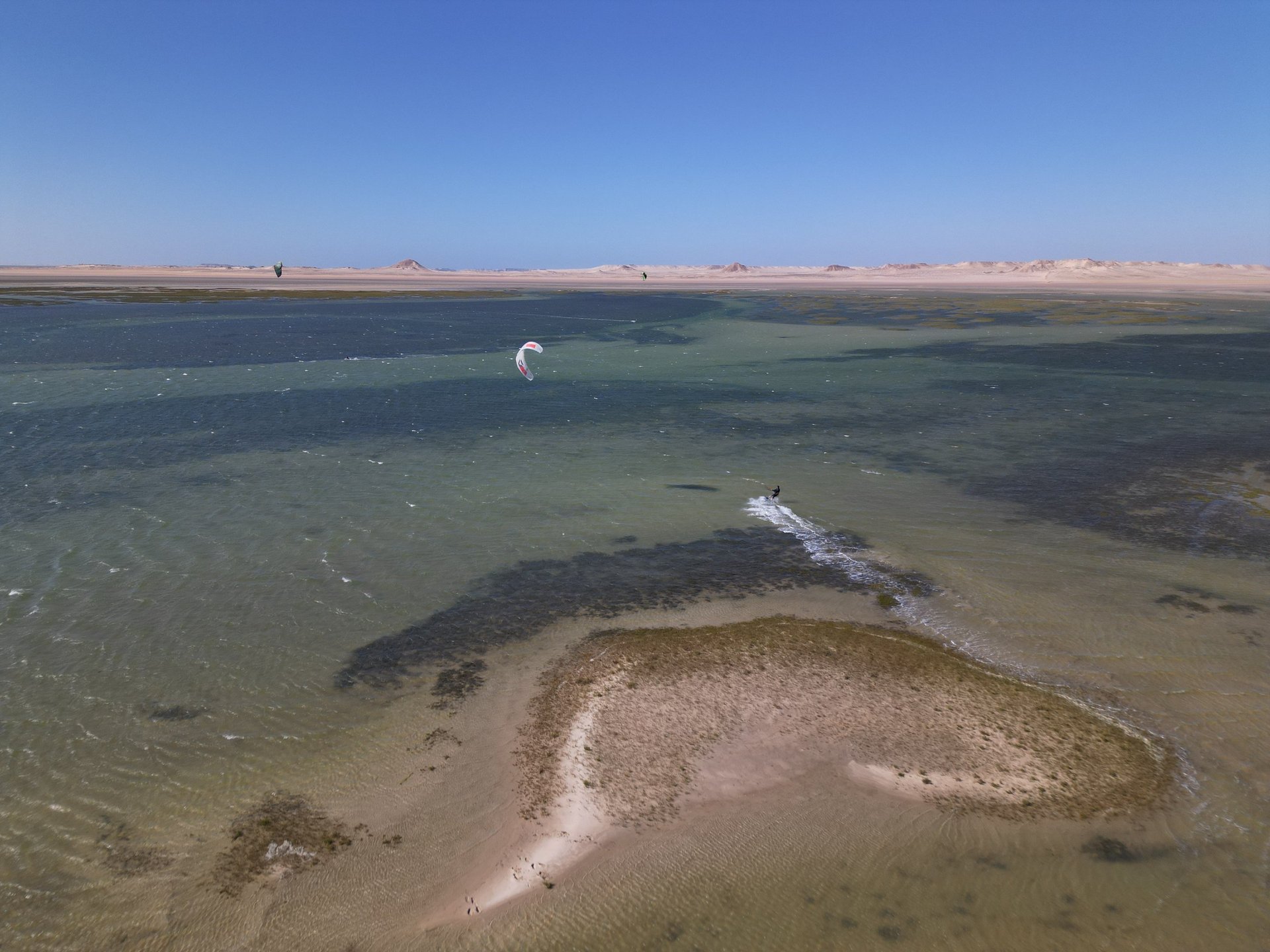 white and brown concrete building near green grass field during daytime