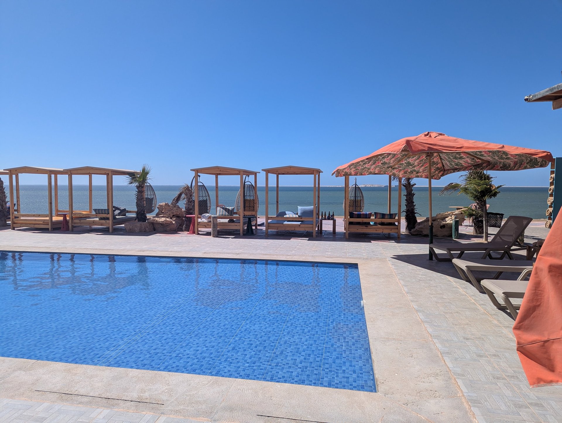 white and brown concrete building near green grass field during daytime