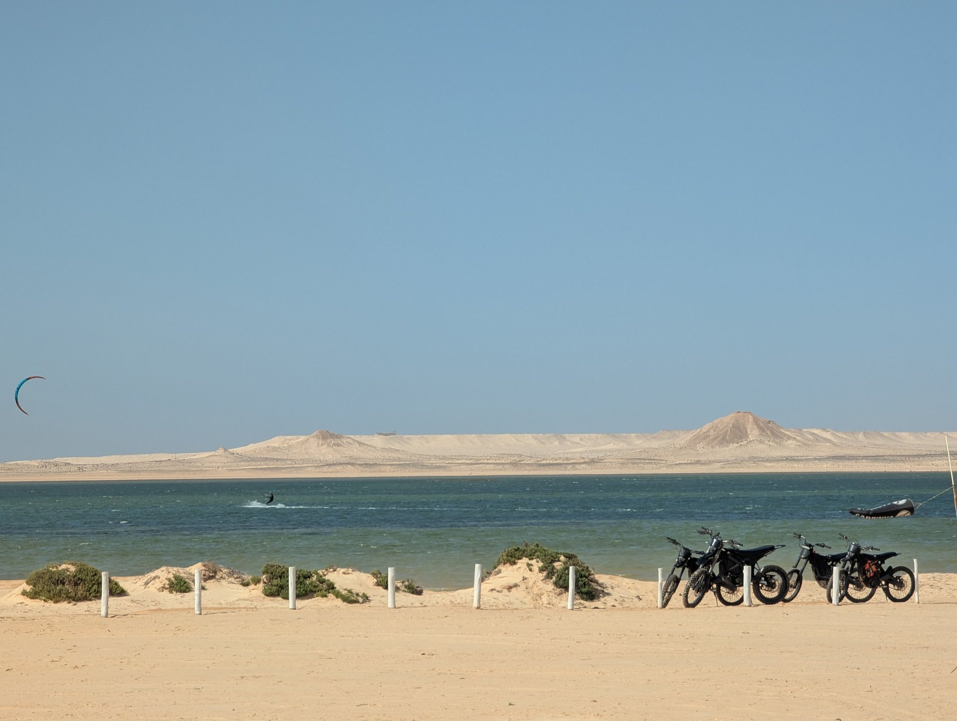 white and brown concrete building near green grass field during daytime