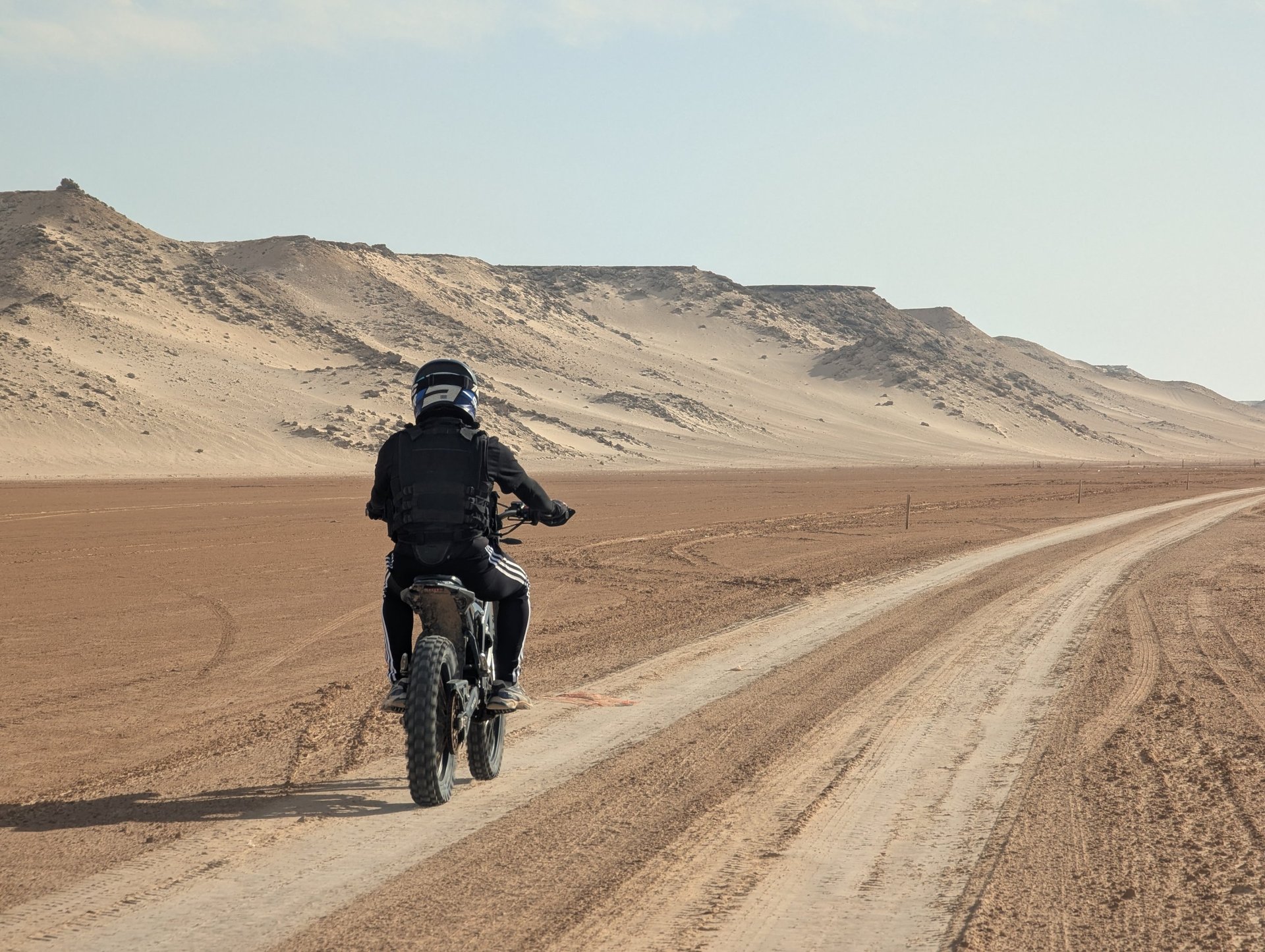 white and brown concrete building near green grass field during daytime