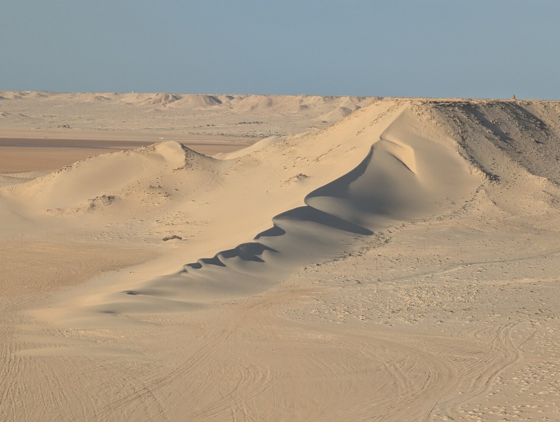 white and brown concrete building near green grass field during daytime