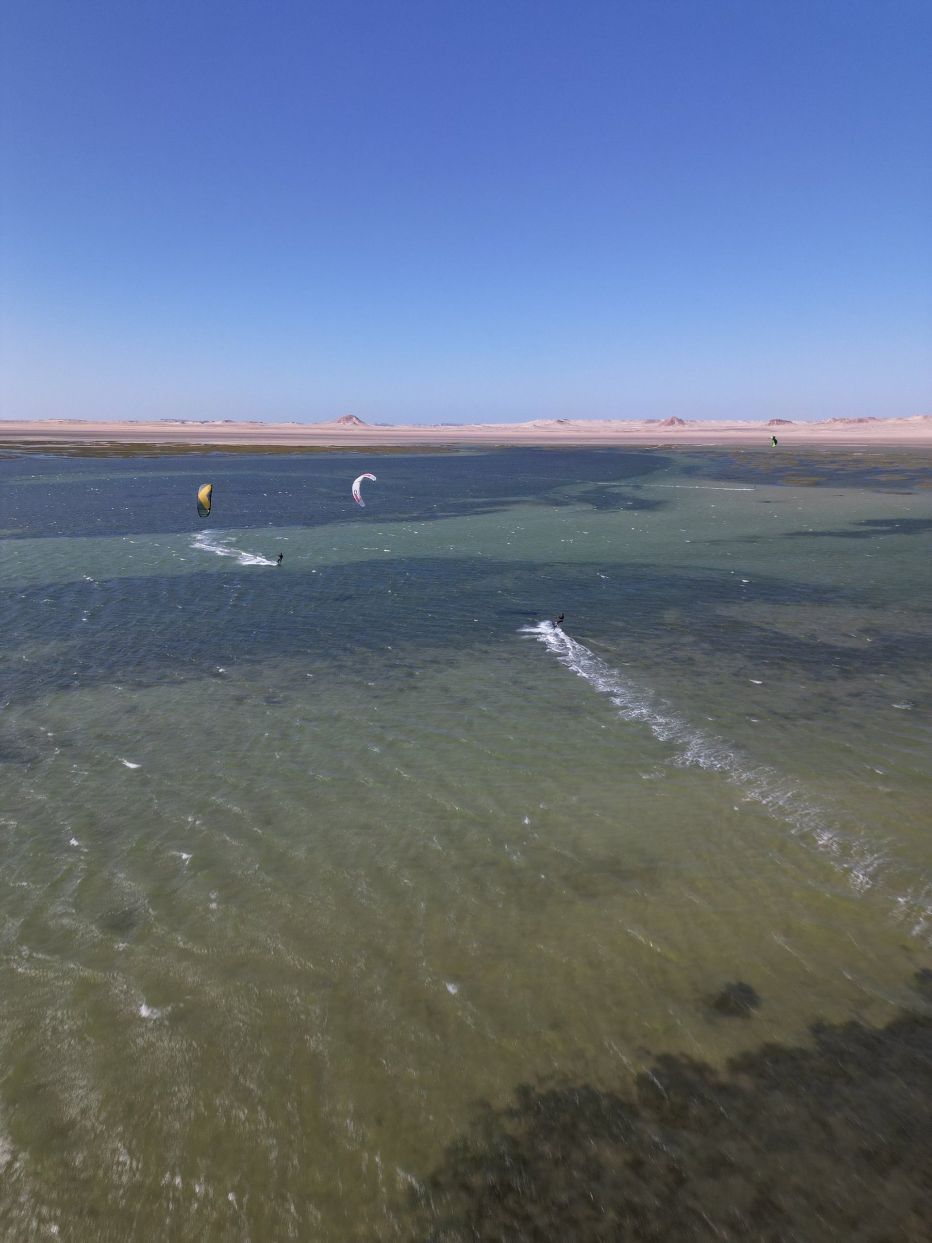 white and brown concrete building near green grass field during daytime