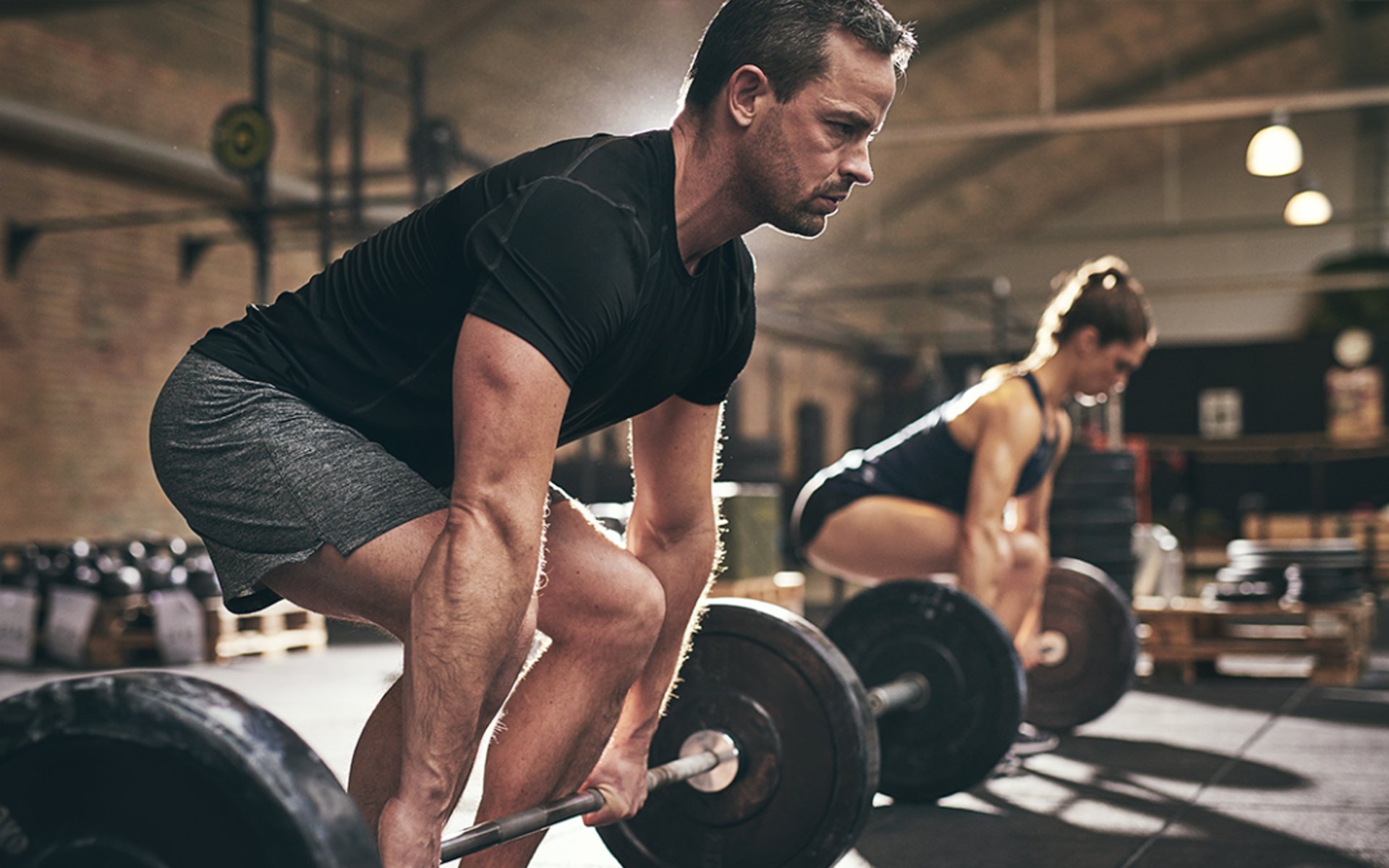 black barbell on tile flooring