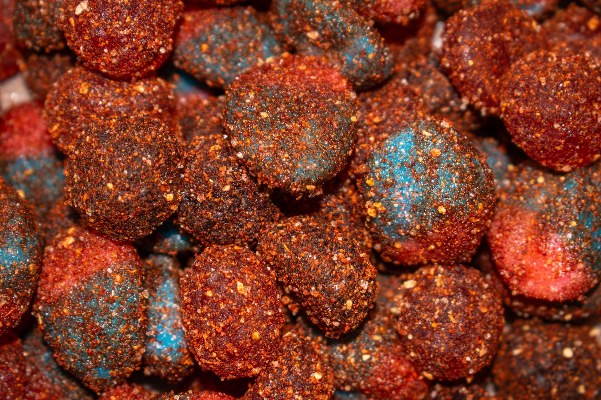 zoom of chili flavored gummies, coated in a granulated chili powder