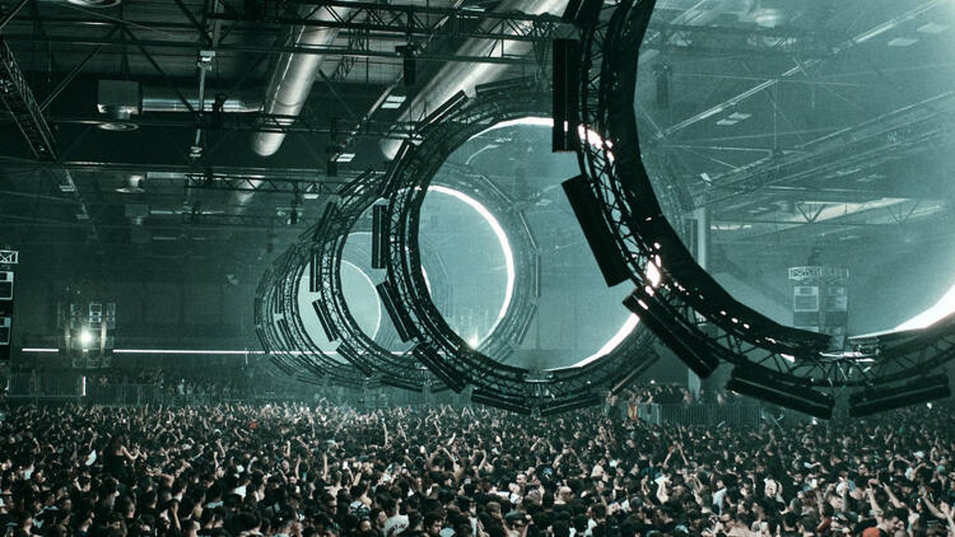 an abstract photo of a curved building with a blue sky in the background