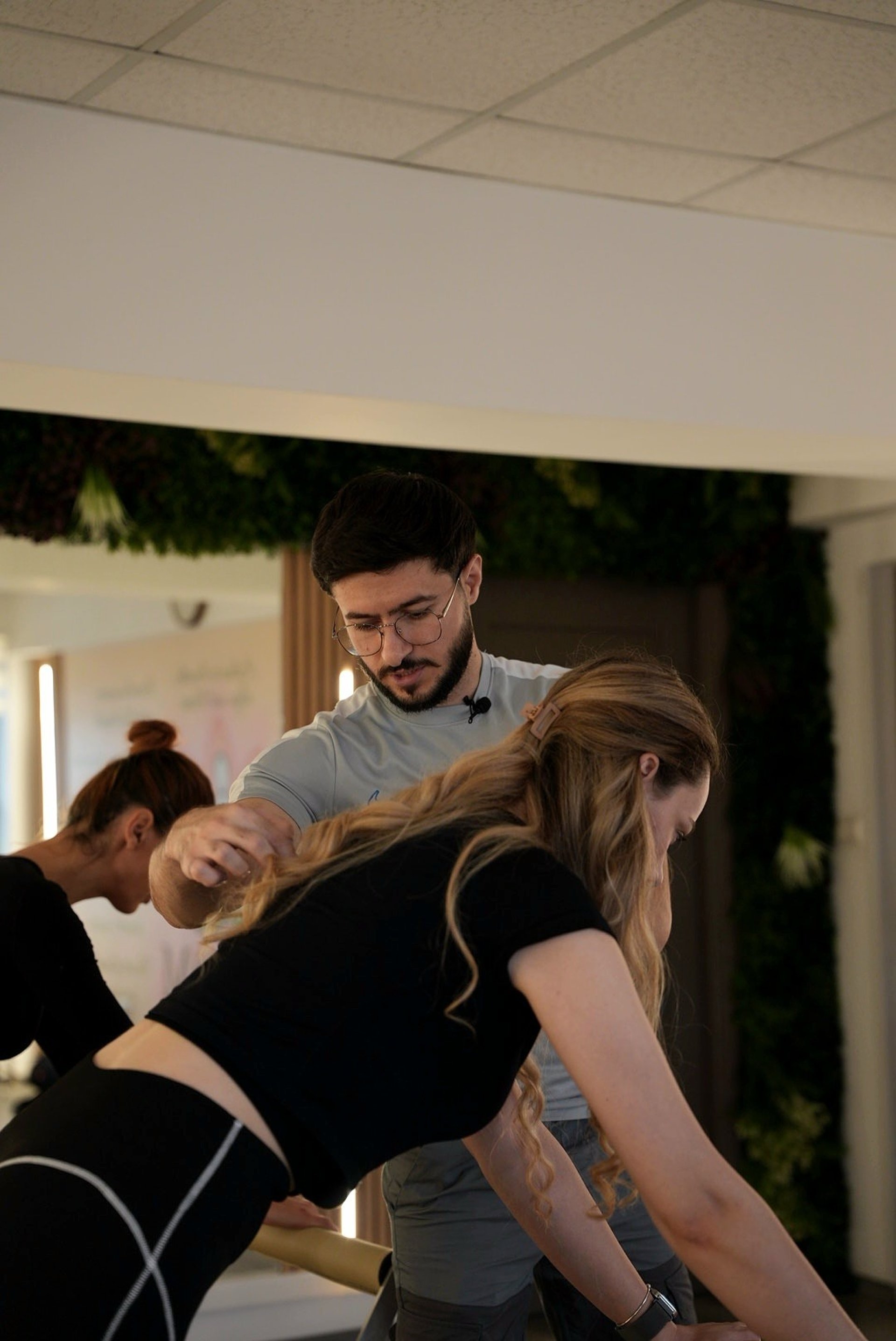 woman in black tank top and black pants doing yoga