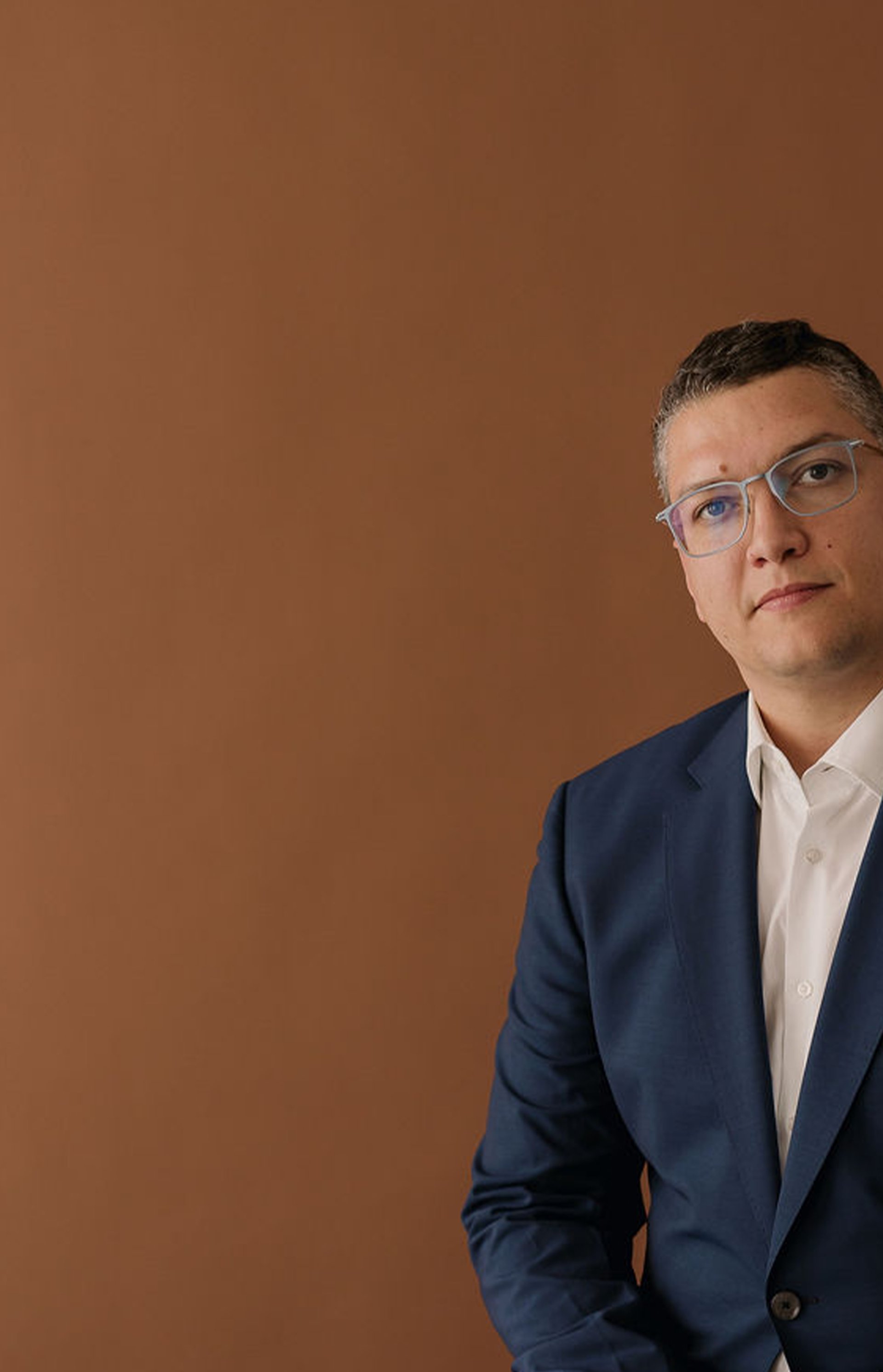 an abstract photo of a curved building with a blue sky in the background