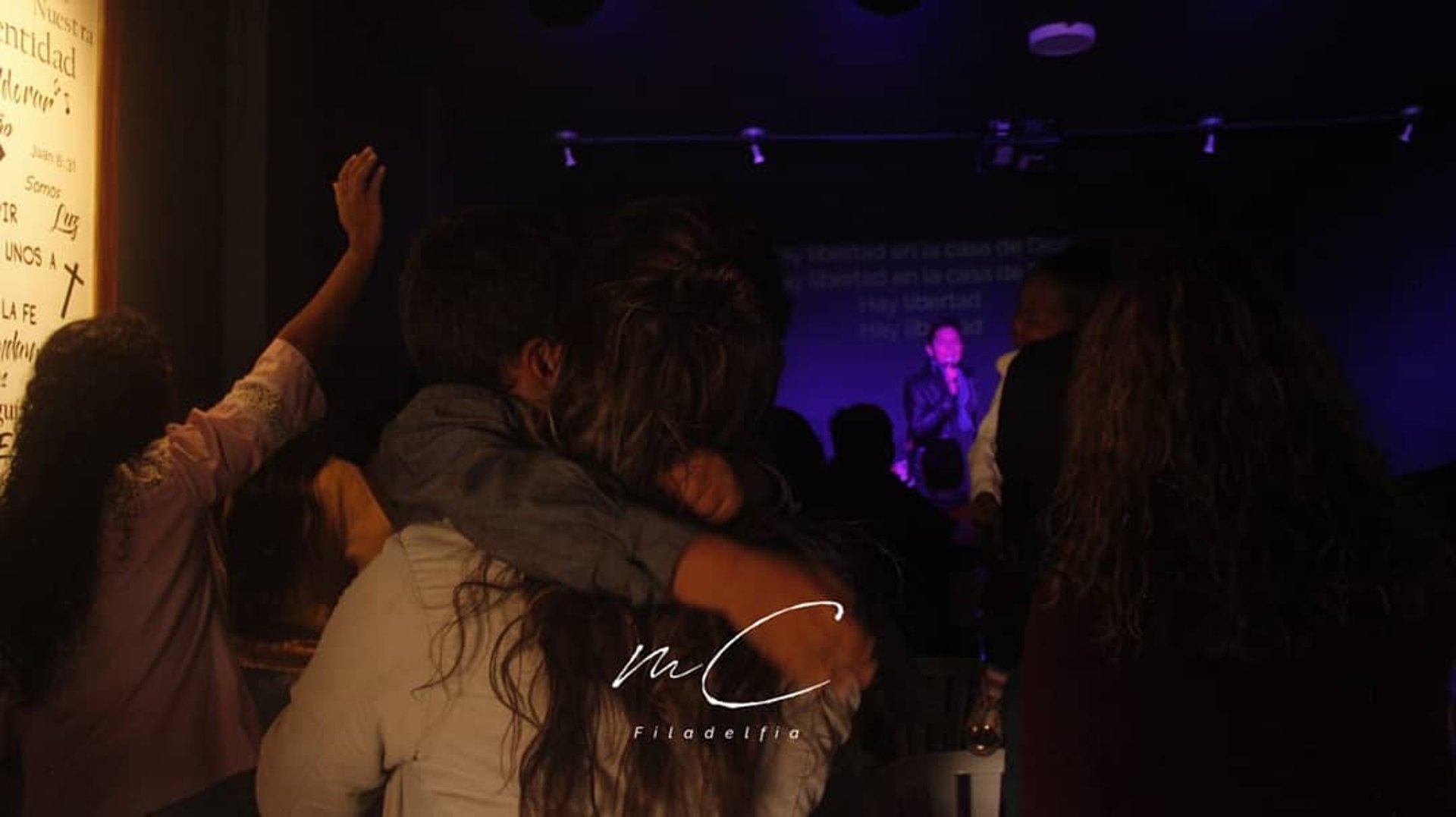 people standing near white cross