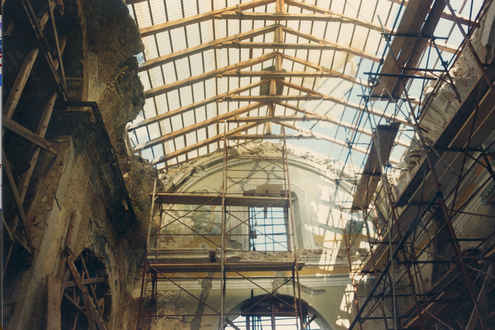 an abstract photo of a curved building with a blue sky in the background