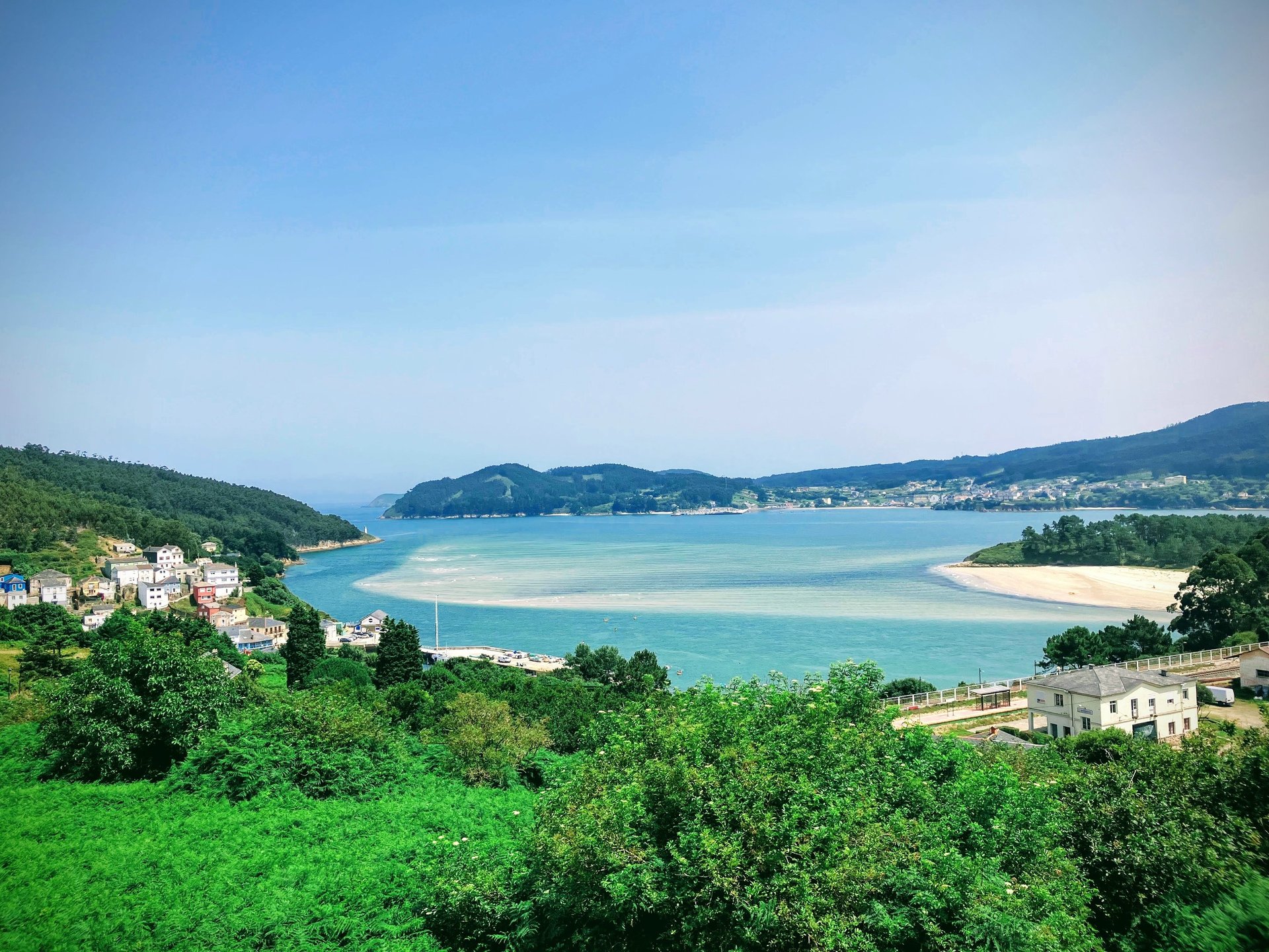 a harbor filled with lots of boats next to tall buildings
