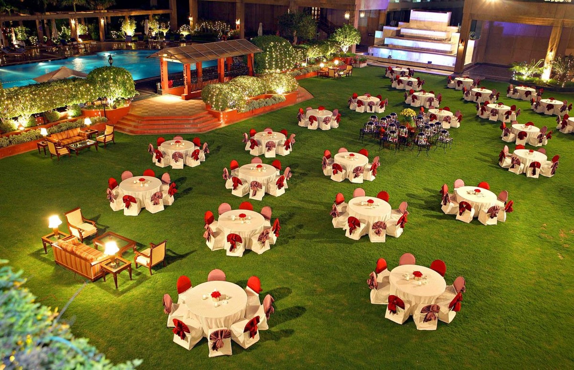 brown wooden bed frame with white and red floral bed linen