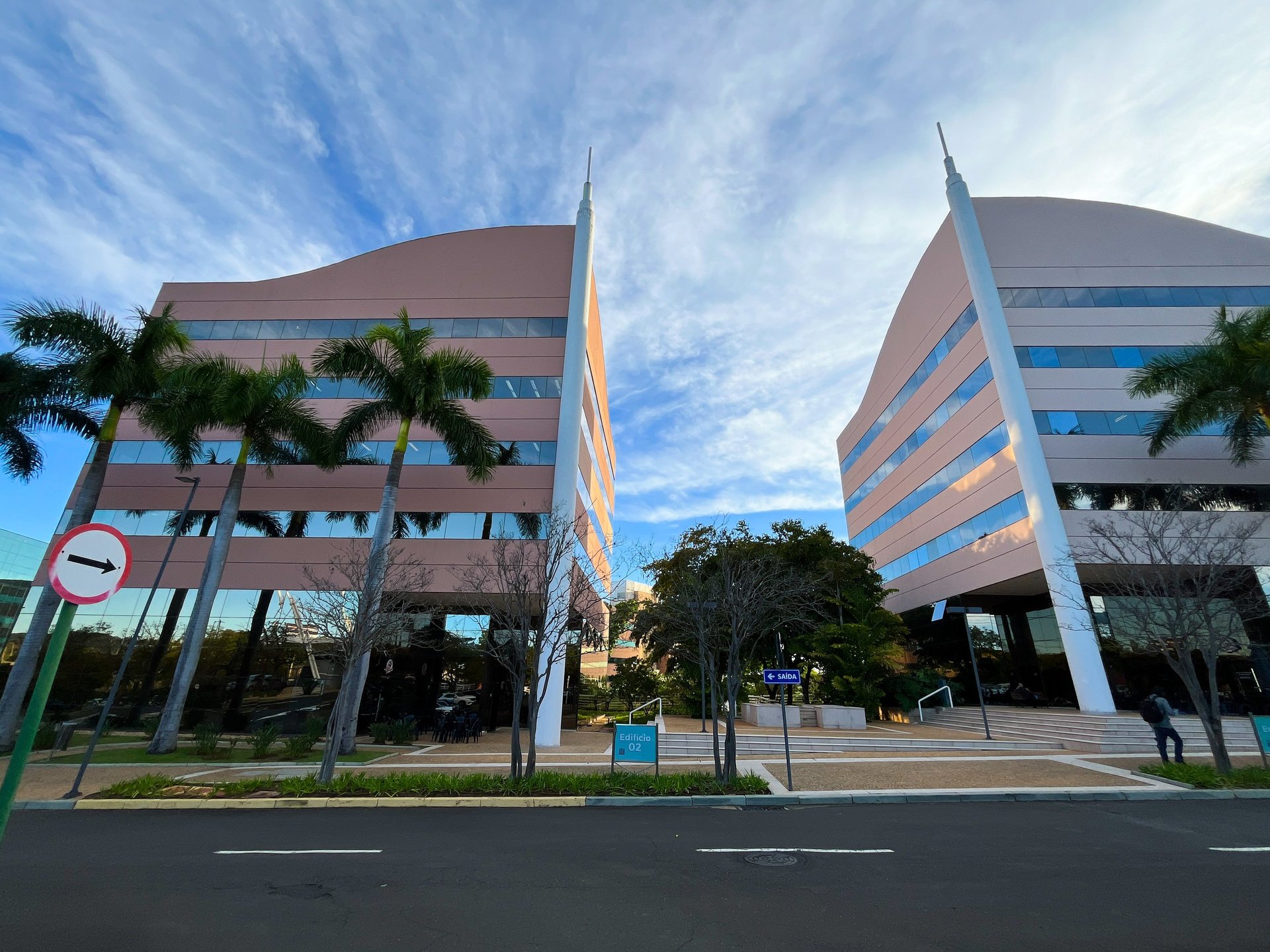 a city skyline with tall buildings and palm trees