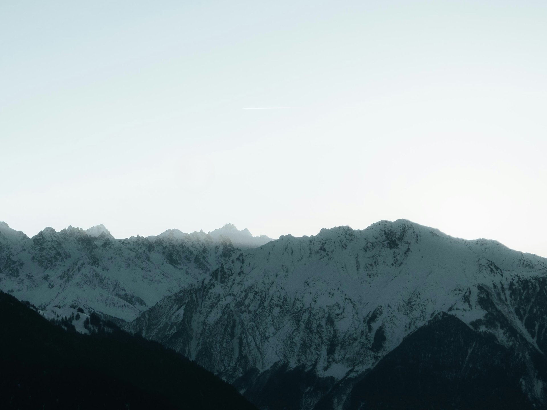 a grassy hill with a mountain in the background