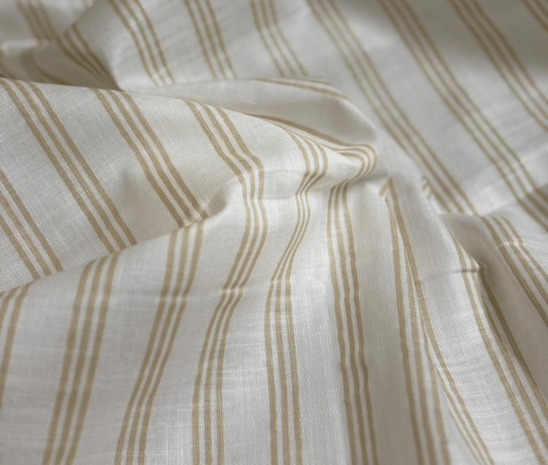 a close up of a bed with a white sheet