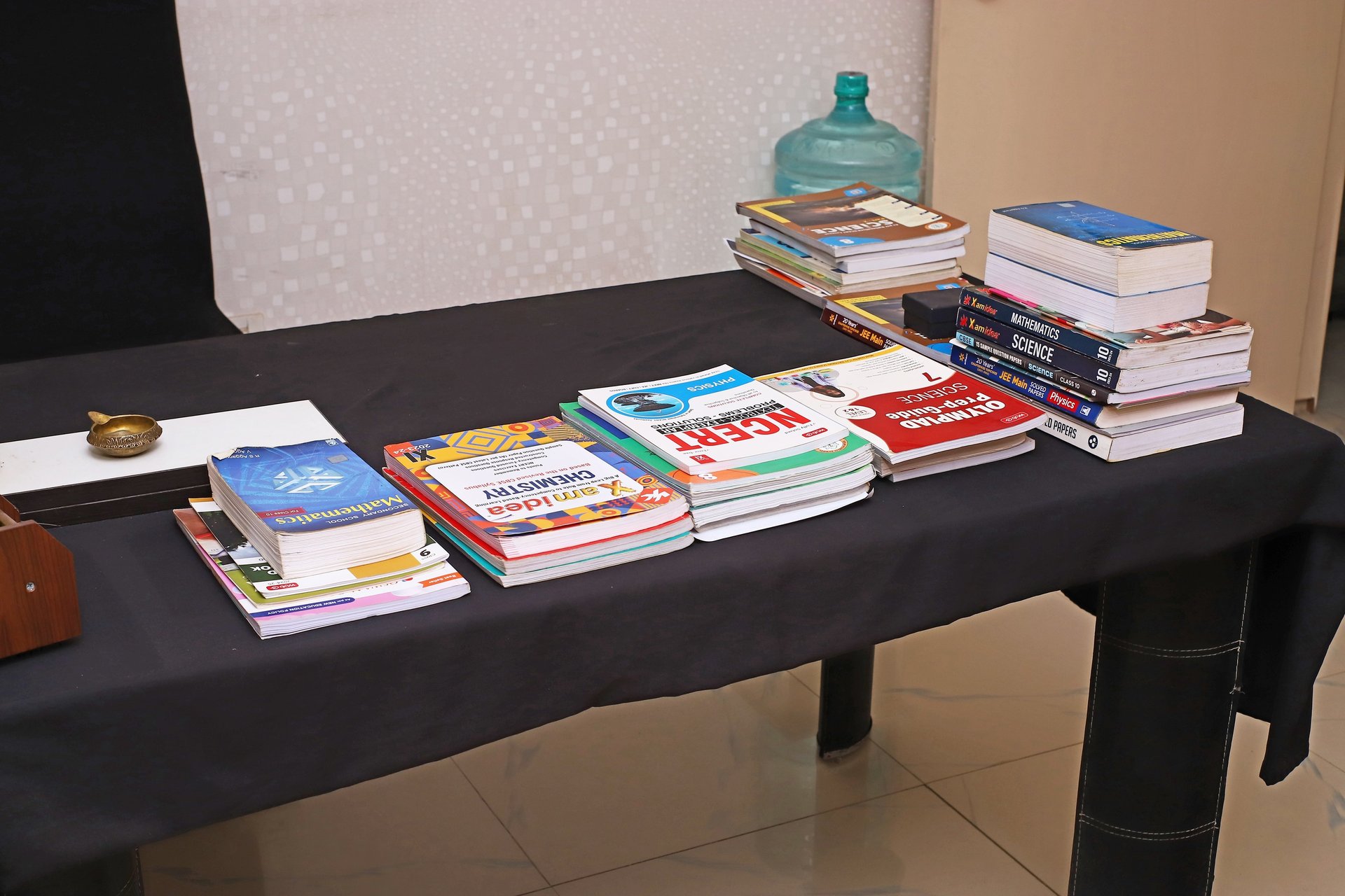 pile of books beside white printer paper and black ballpoint pen