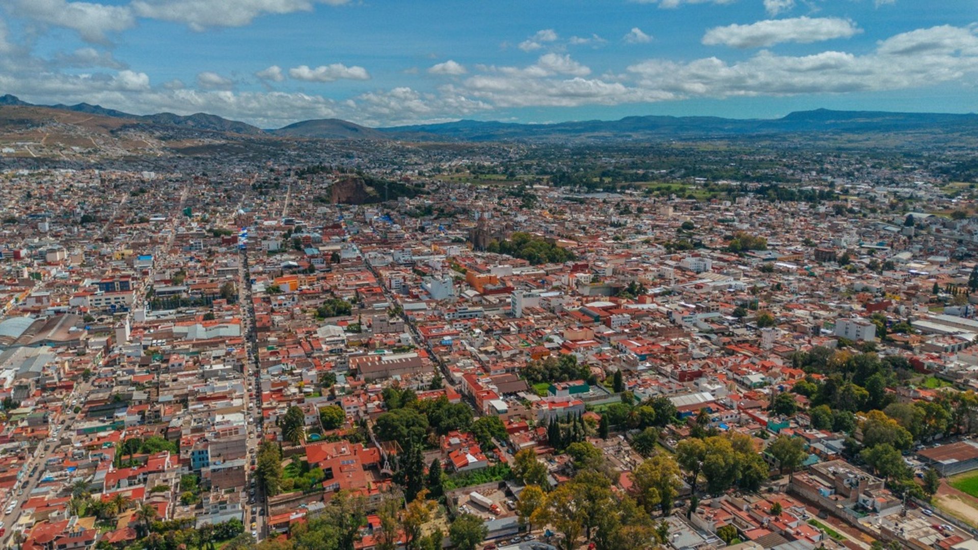 yellow plastic chair near brown rock formation