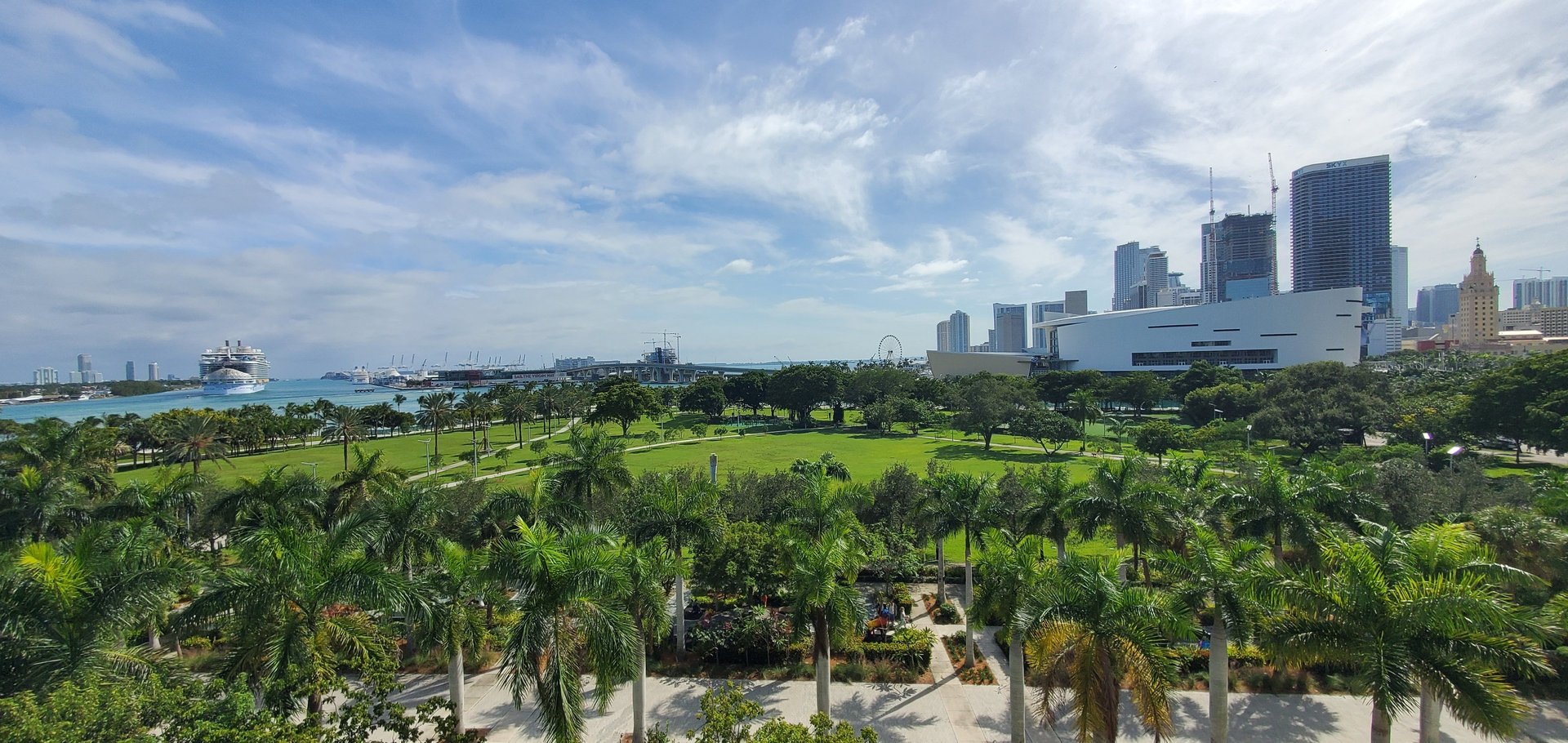 woman wearing yellow long-sleeved dress under white clouds and blue sky during daytime
