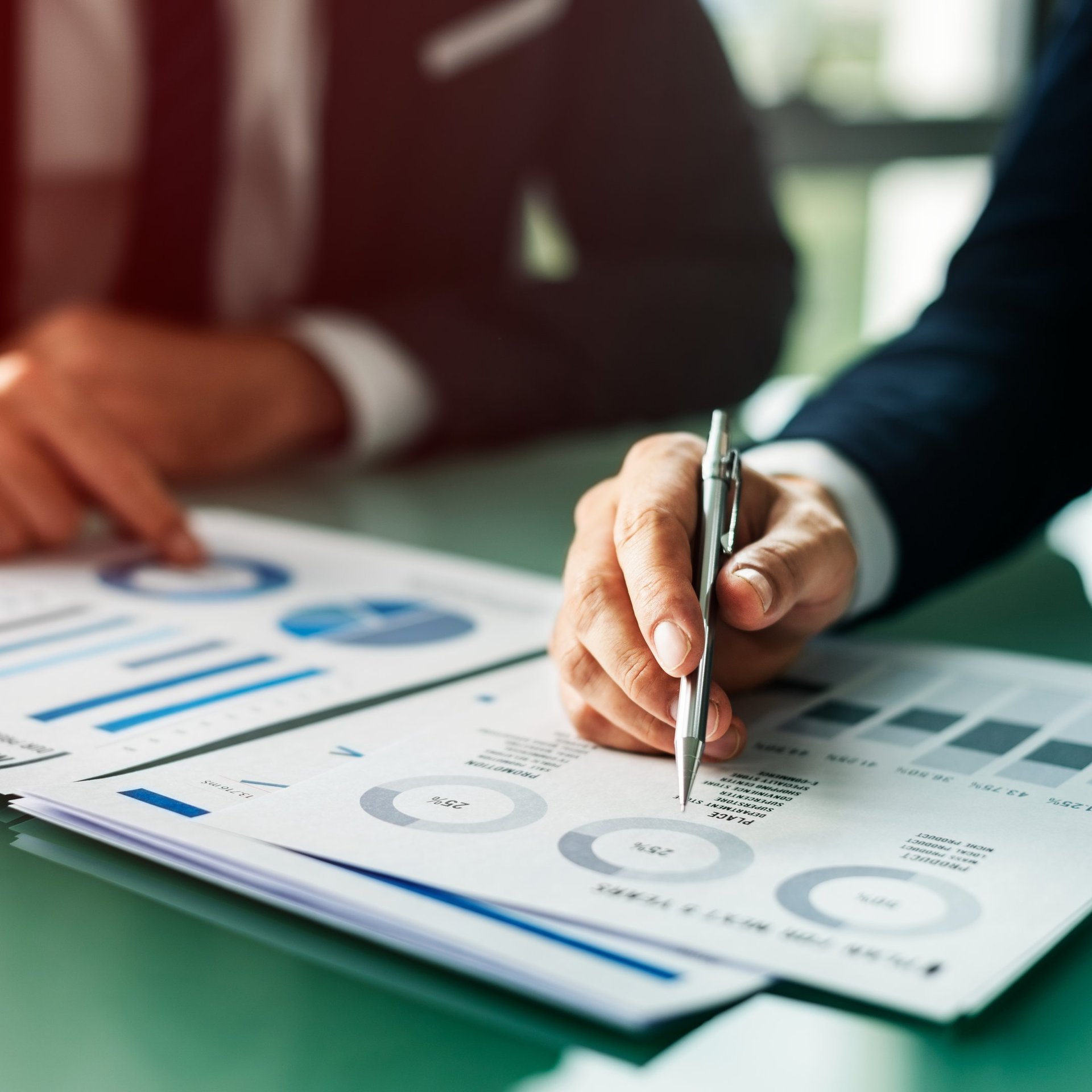 person in black suit jacket holding white tablet computer