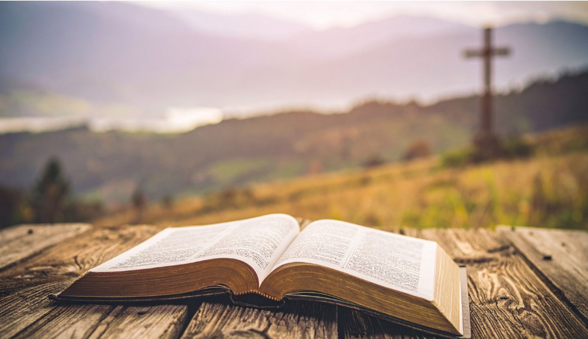 an open book sitting on top of a wooden table