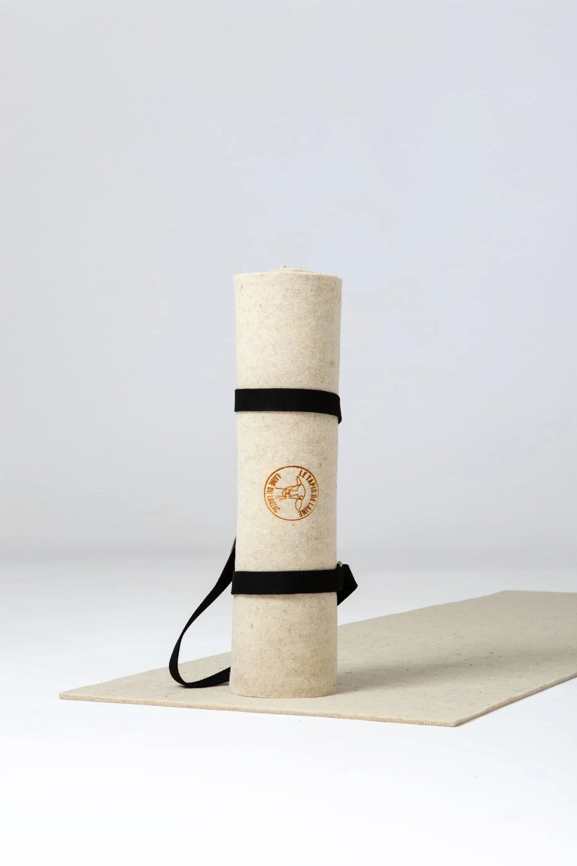 A wooden table topped with a basket next to a blue blanket