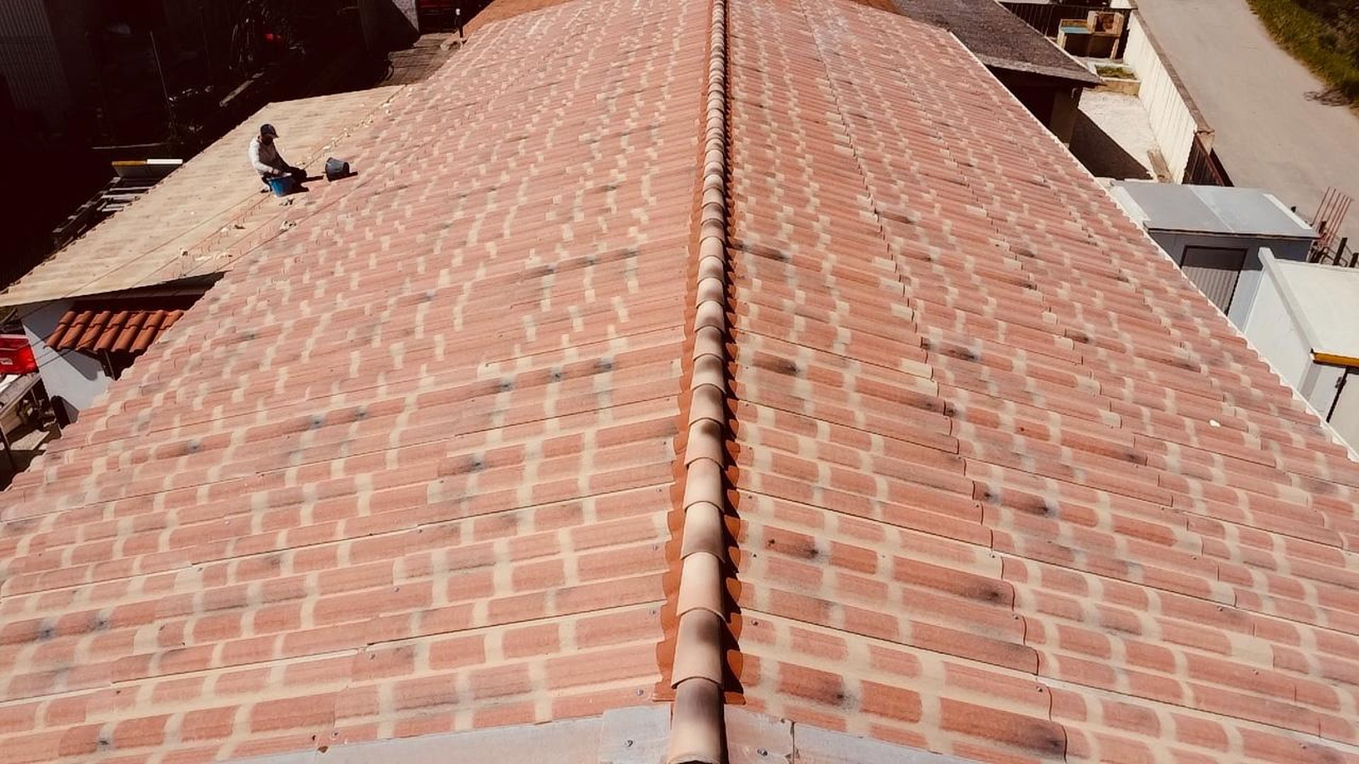 a man on a roof working with a rope