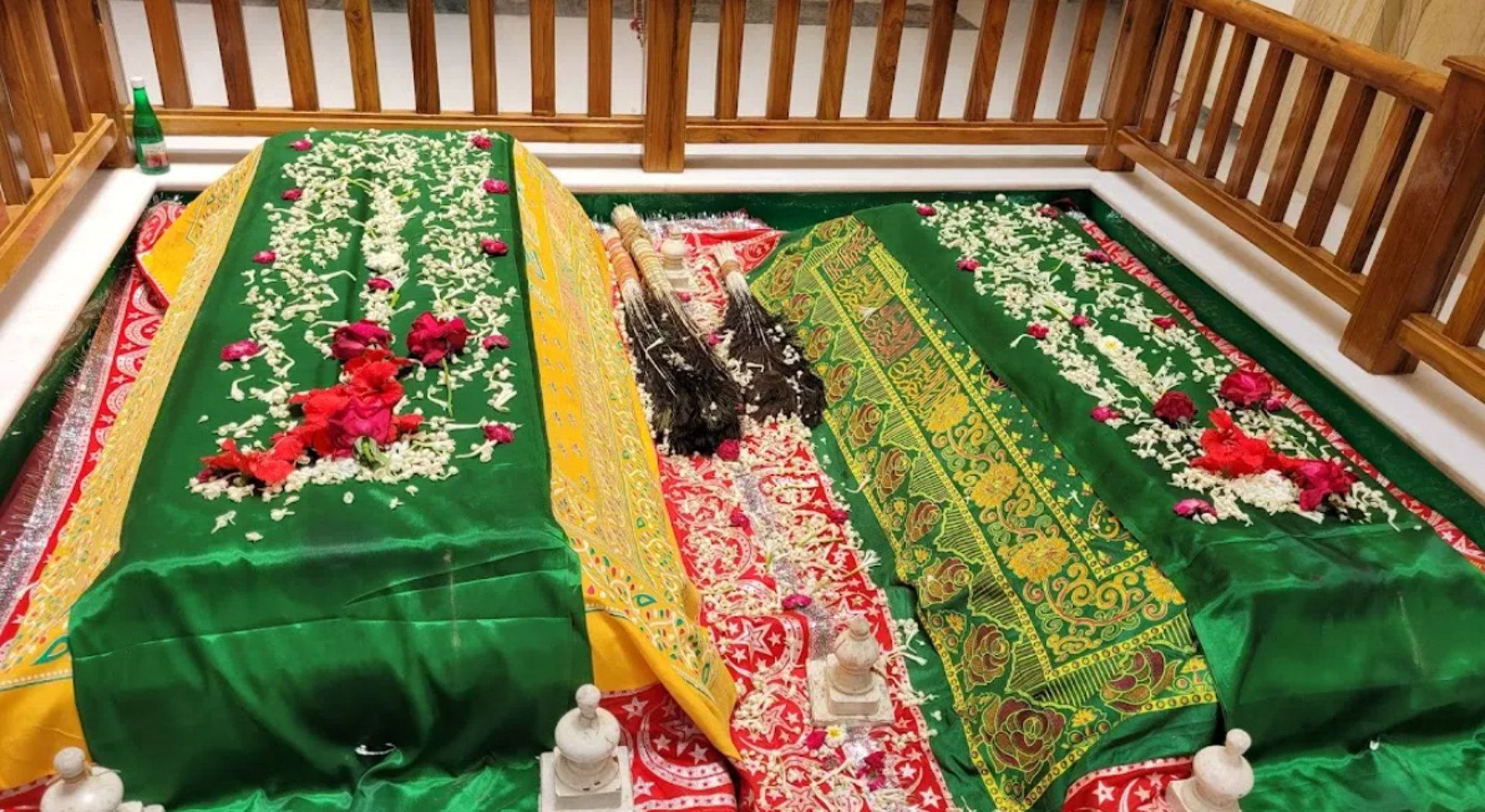 brown concrete Ganesha statue standing behind the plants