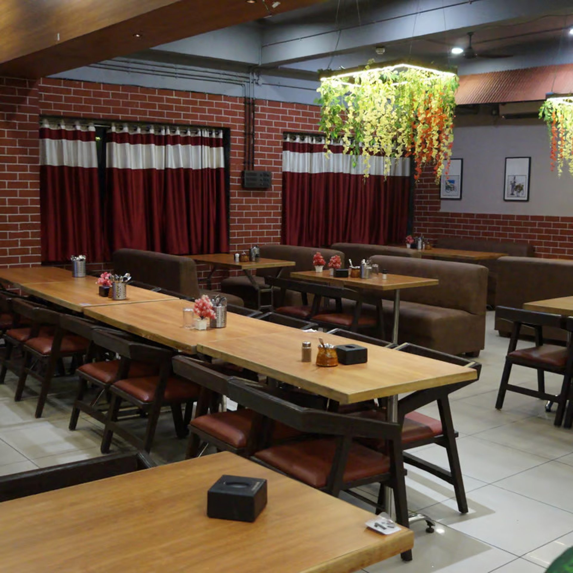 a dimly lit dining room with tables and chairs